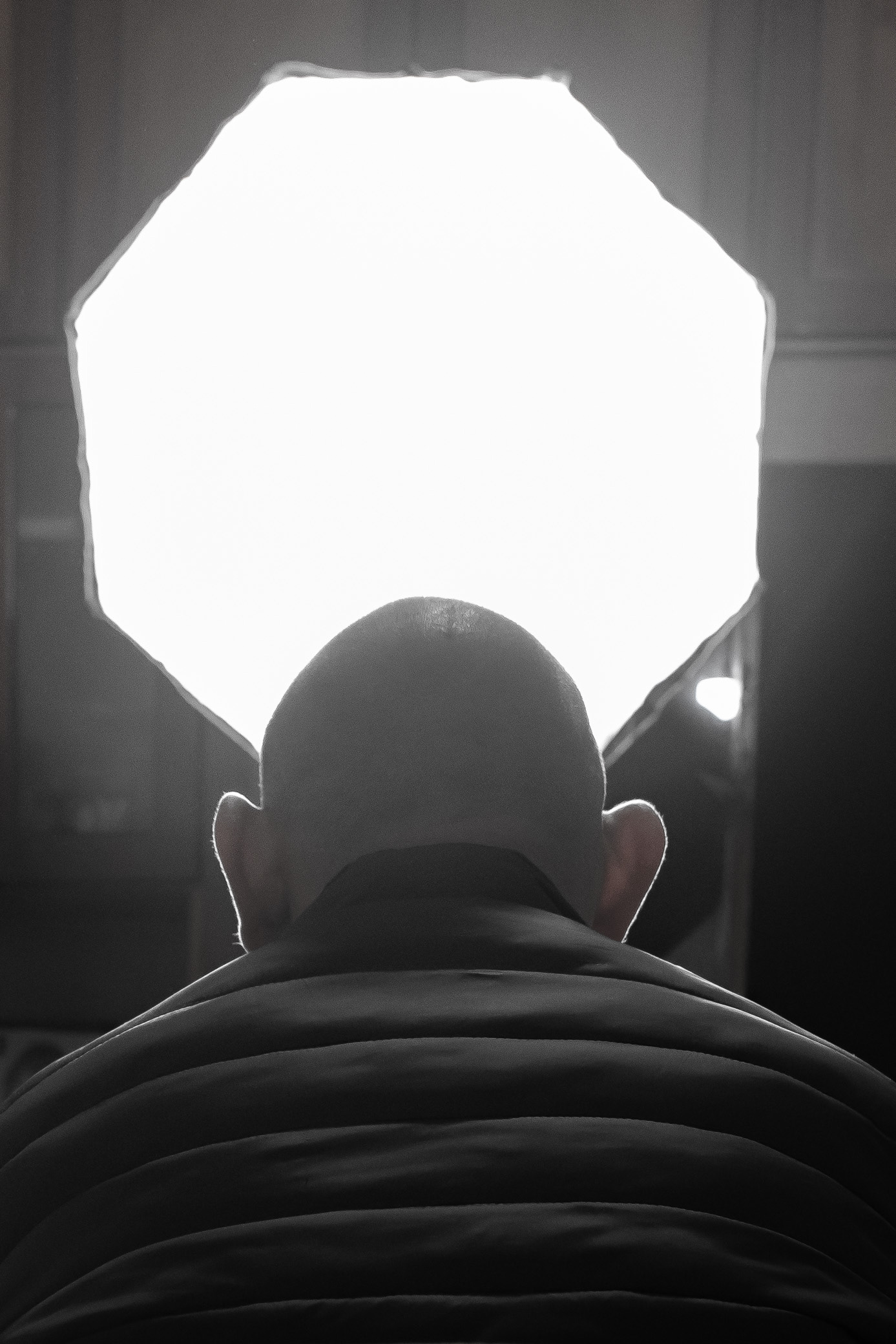 Fatima's disabled son, his eyes fixed on the soft glow of the spotlight that gently bathes the room in light. Photo © Marek Ladzinski.