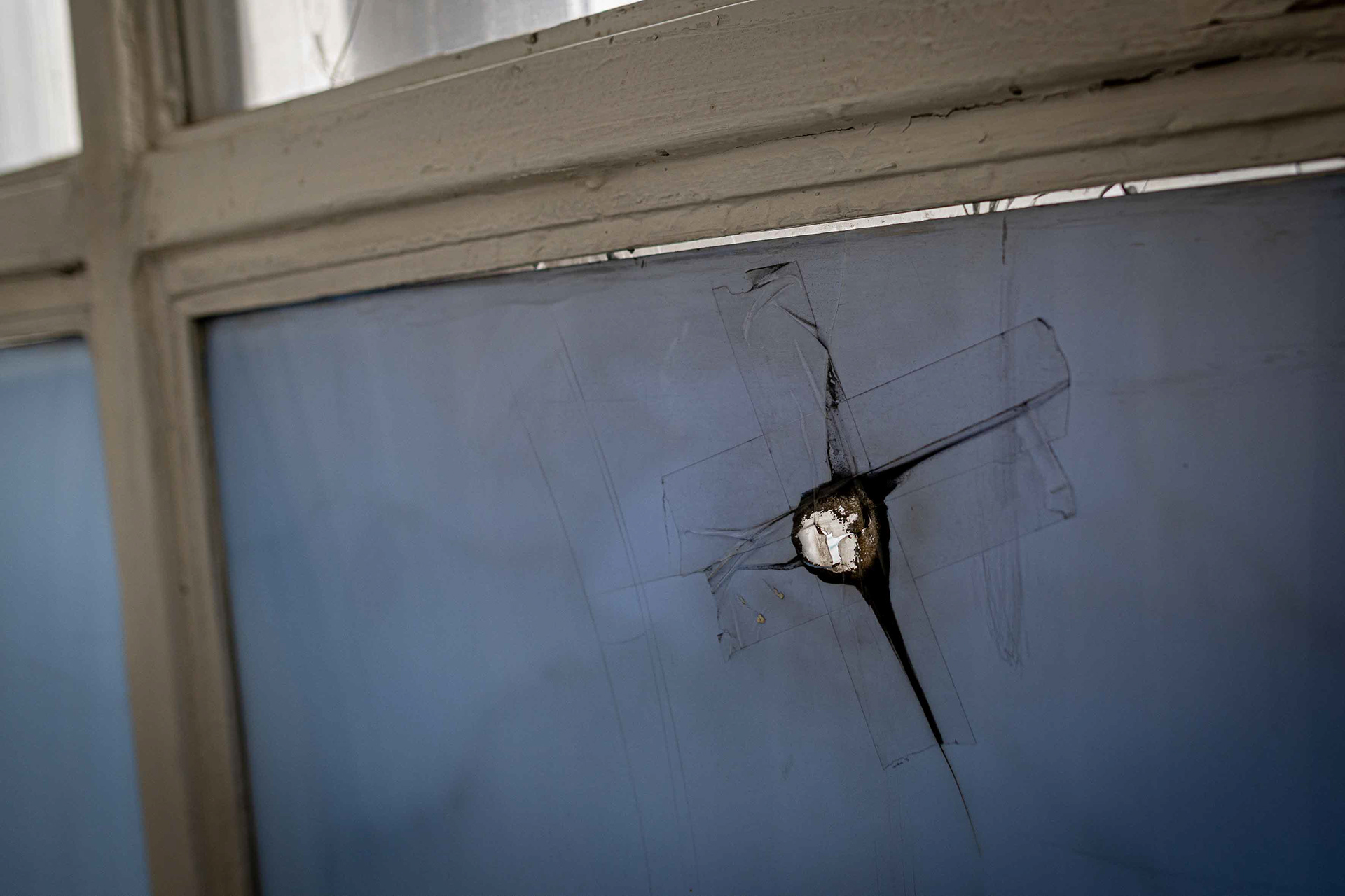 A bullet impact mark in one of the windows. © Marek Ladzinski / Zuma Press