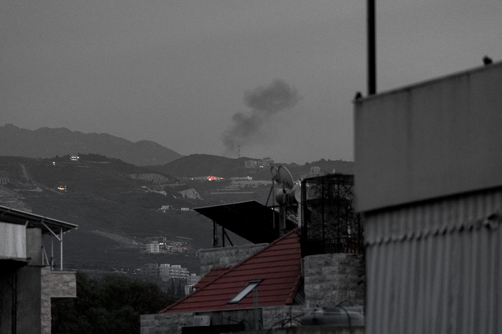 During the interview with Fatima, smoke and flames rose from the hillside outside the window — a calm yet poignant backdrop to her moving story. Photo © Marek Ladzinski.