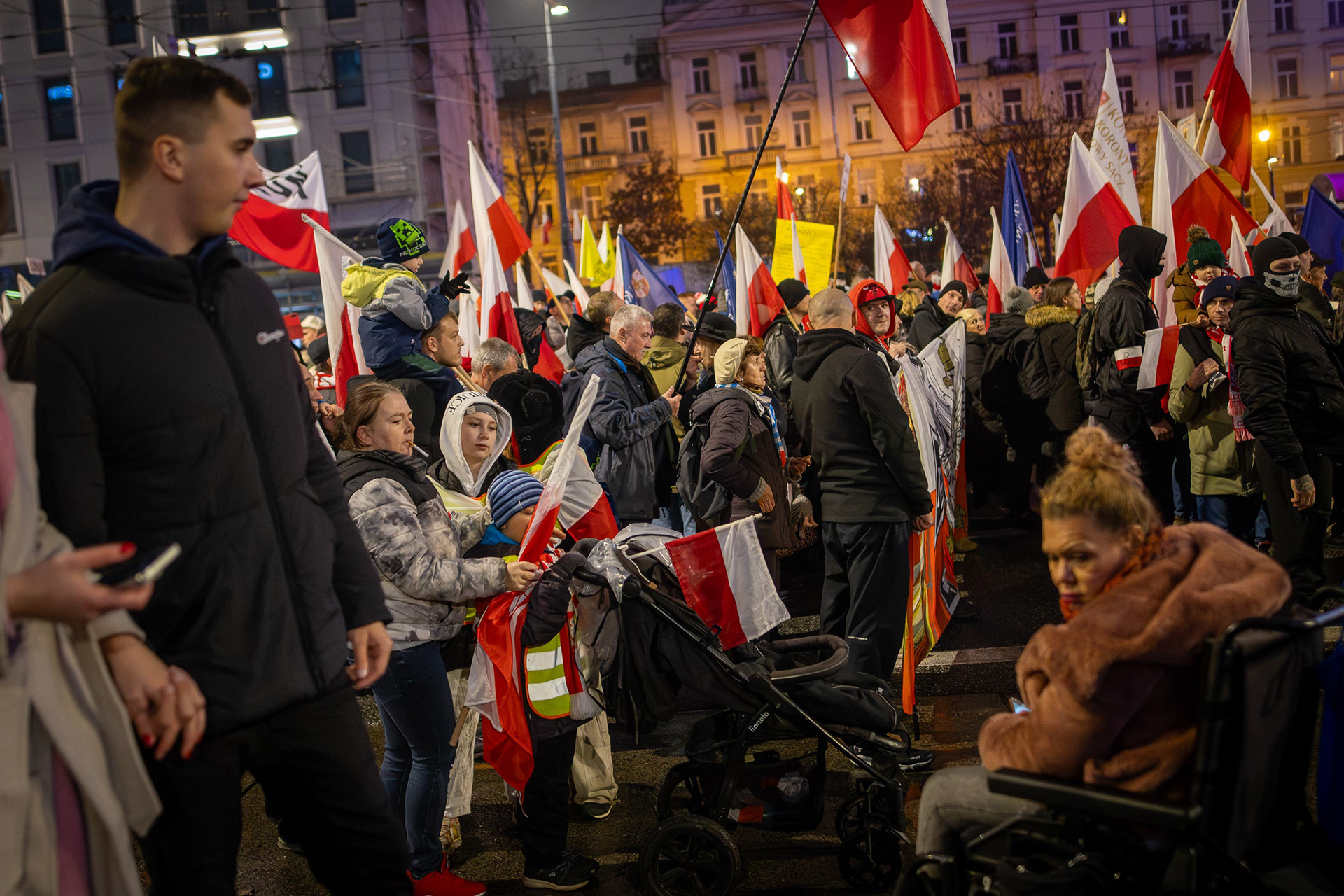 People march with Polish flags during Independence Day celebrations in Warsaw. Photo © Marek Ladzinski