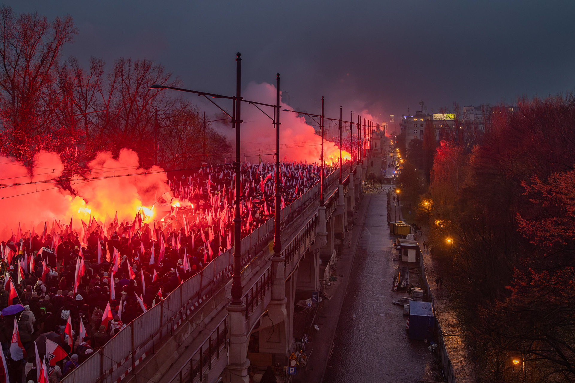 View of people marching across a bridge during Independence Day celebrations in Warsaw. Photo © Marek Ladzinski