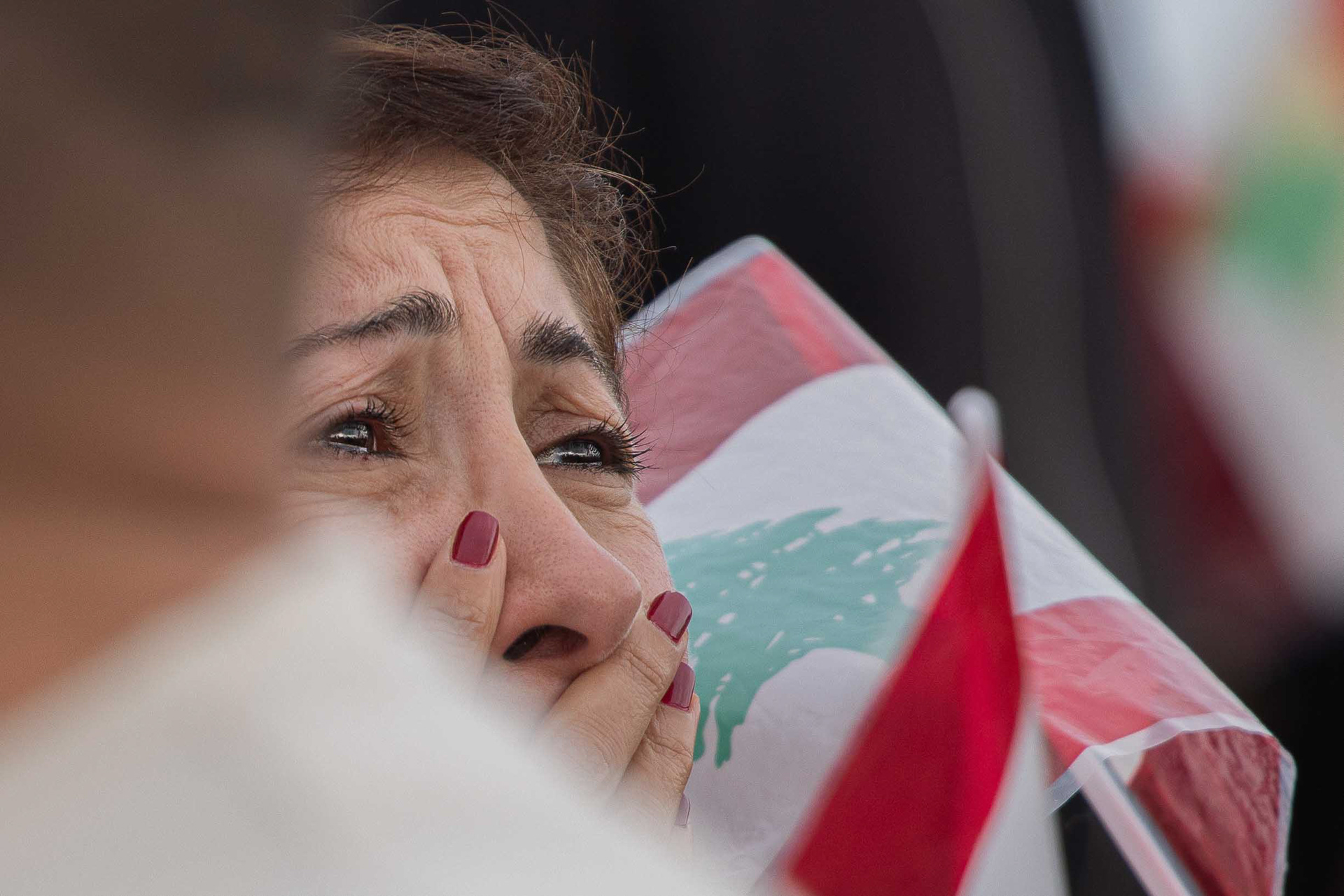 A woman wipes away tears, visibly moved during the Mass concelebrated by Pope Leo XIV in Beirut, touched by the prayers and the sacred atmosphere of the liturgy. Photo by: © Marek Ladzinski/ZUMA Press Wire