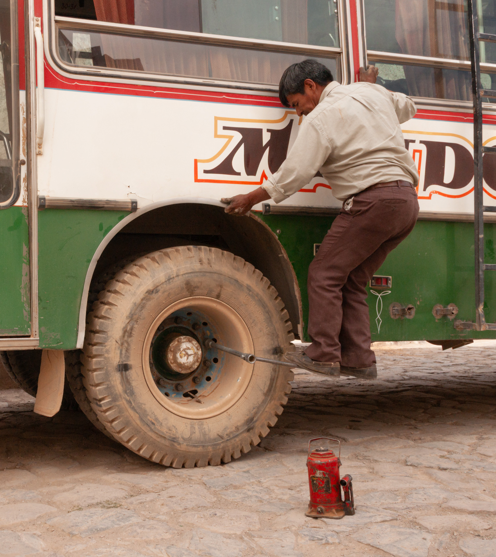 Bus Driver tightening the Wheel Nuts. Iruya.