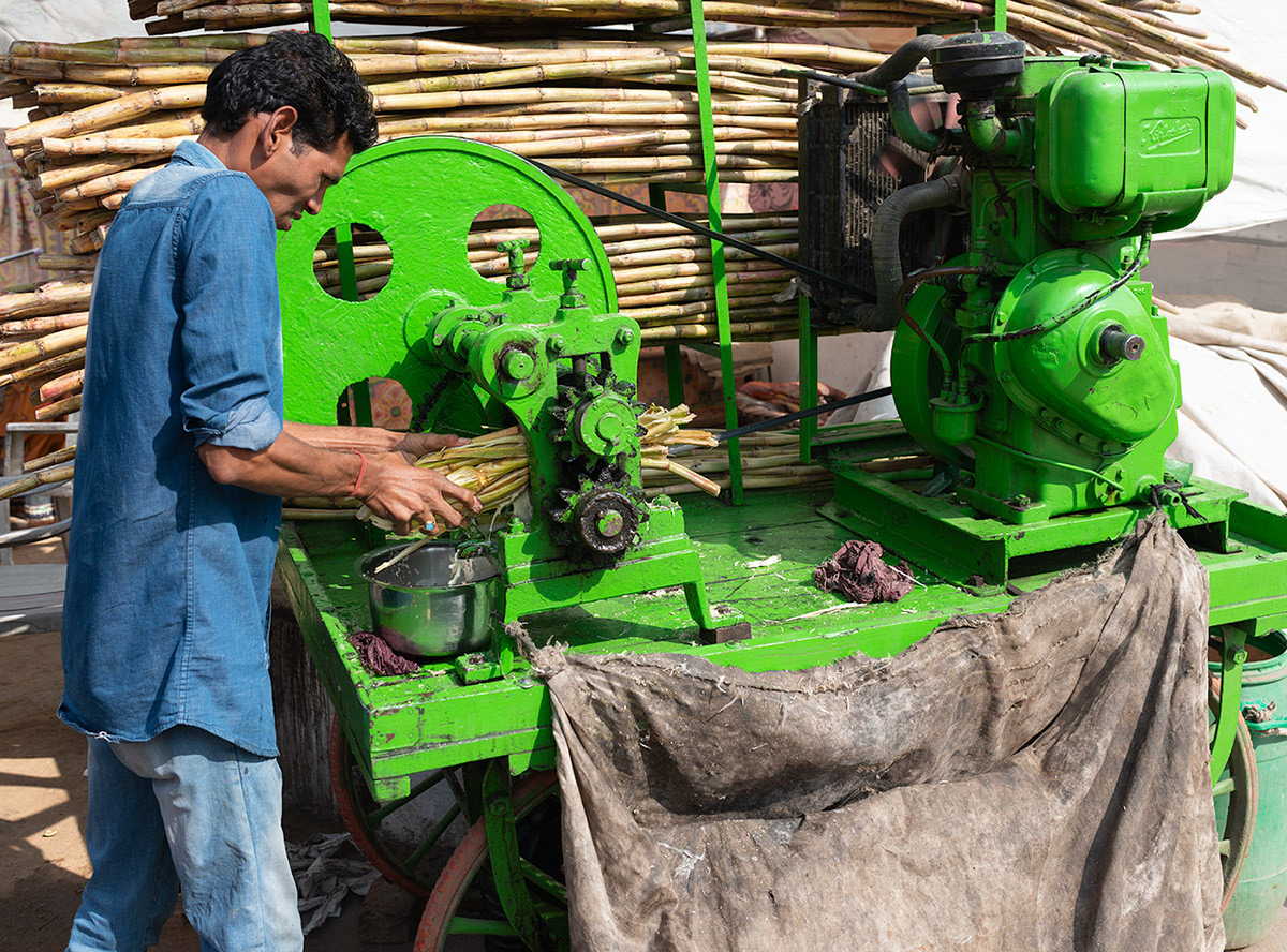 Man operating sugar cane crusher. Pushkar, 2016.