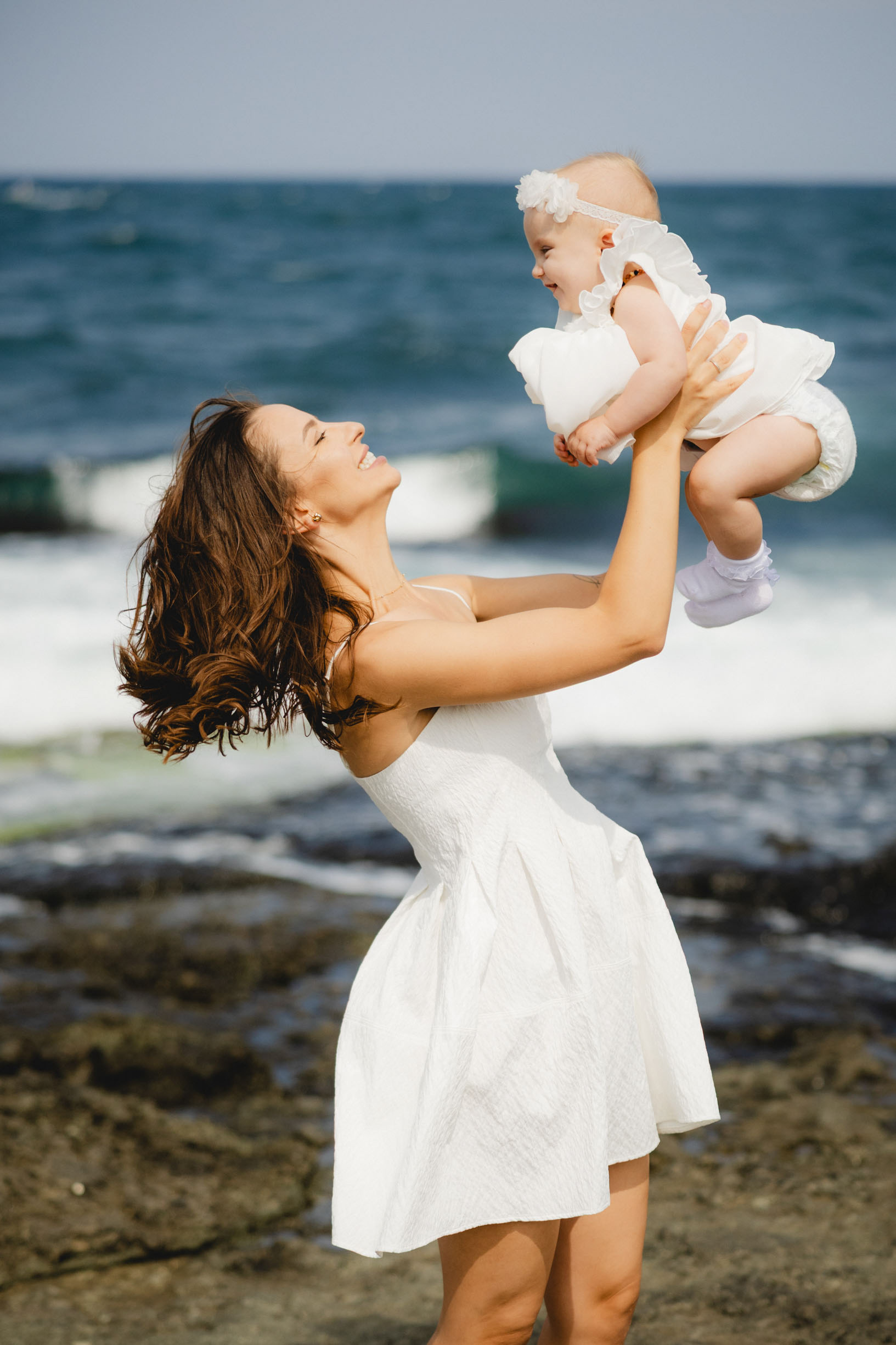Майка се радва на кръстеното си дете. Снимка от професионален фотограф Царево.