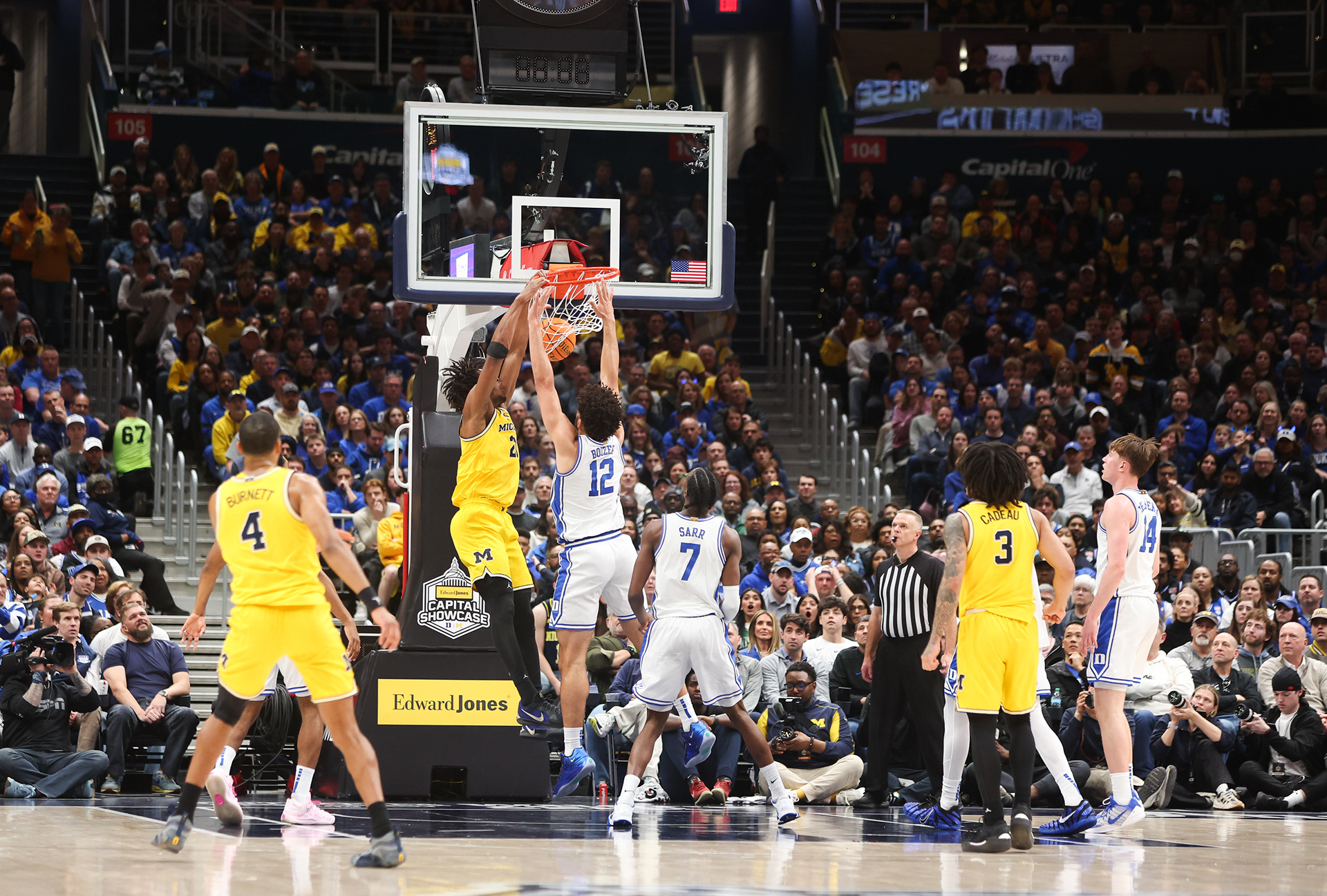 Washington, DC - Michigan Sophomore Forward #21 Morez Johnon Jr. dunks the ball as fellow players and the audience look on during Edward Jones Capital Showcase at Capital One Arena on Febuarary 21st, 2026