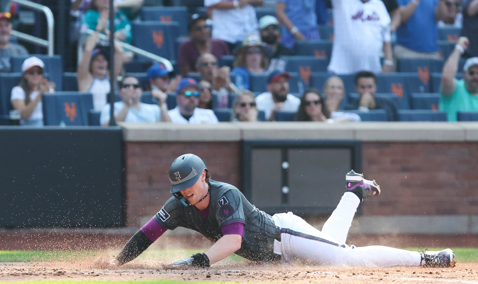 Flushing, NY - New York Mets Third Basemen Brett Baty #7 slides into home during a home game against the Seattle Mariners on August 16th 2025
