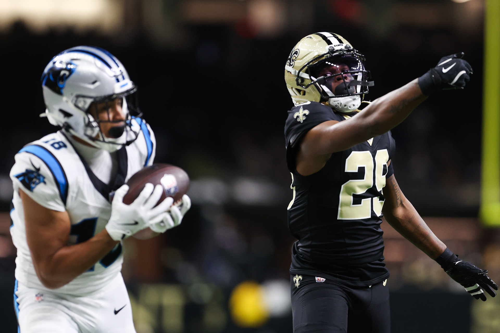New Orleans, LA - Saints CB #29 Quincy Riley looks back at Panthers WR #18 Jalen Coker as he scores a touchdown during week 15 play of the regular season at Caesars Superdome