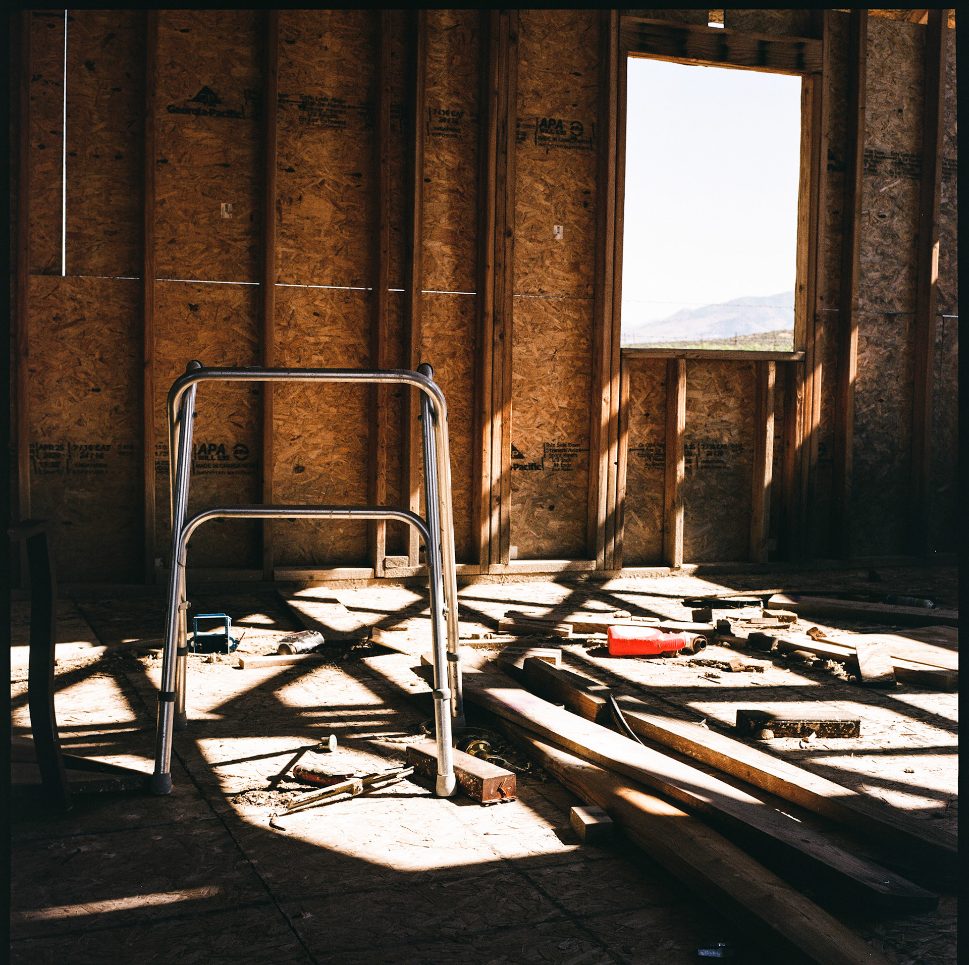 It's Analog Tuesday. I stopped by an abandoned building the other day and captured a picture of this walker through an open door. I always wonder about the stories places like this have to tell.