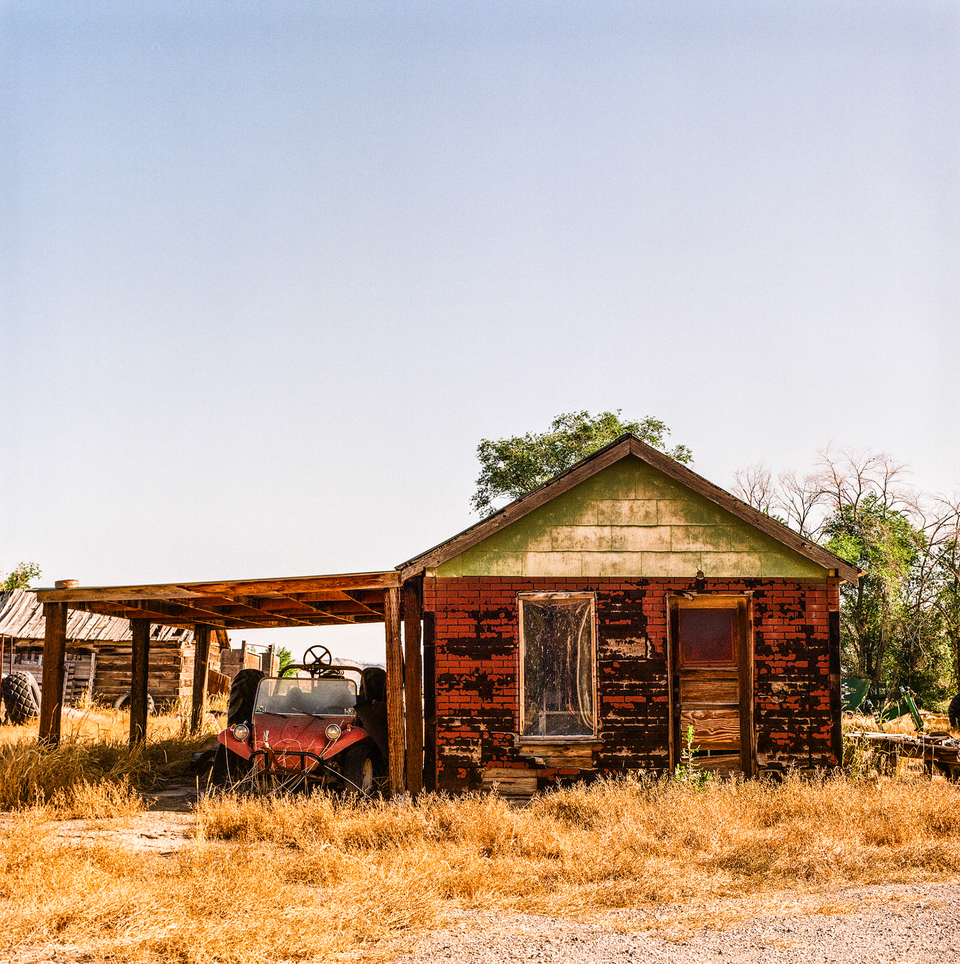 Today is Analog Tuesday. On a recent photo safari, I found this old red building sheltering a old red dunebuggy.