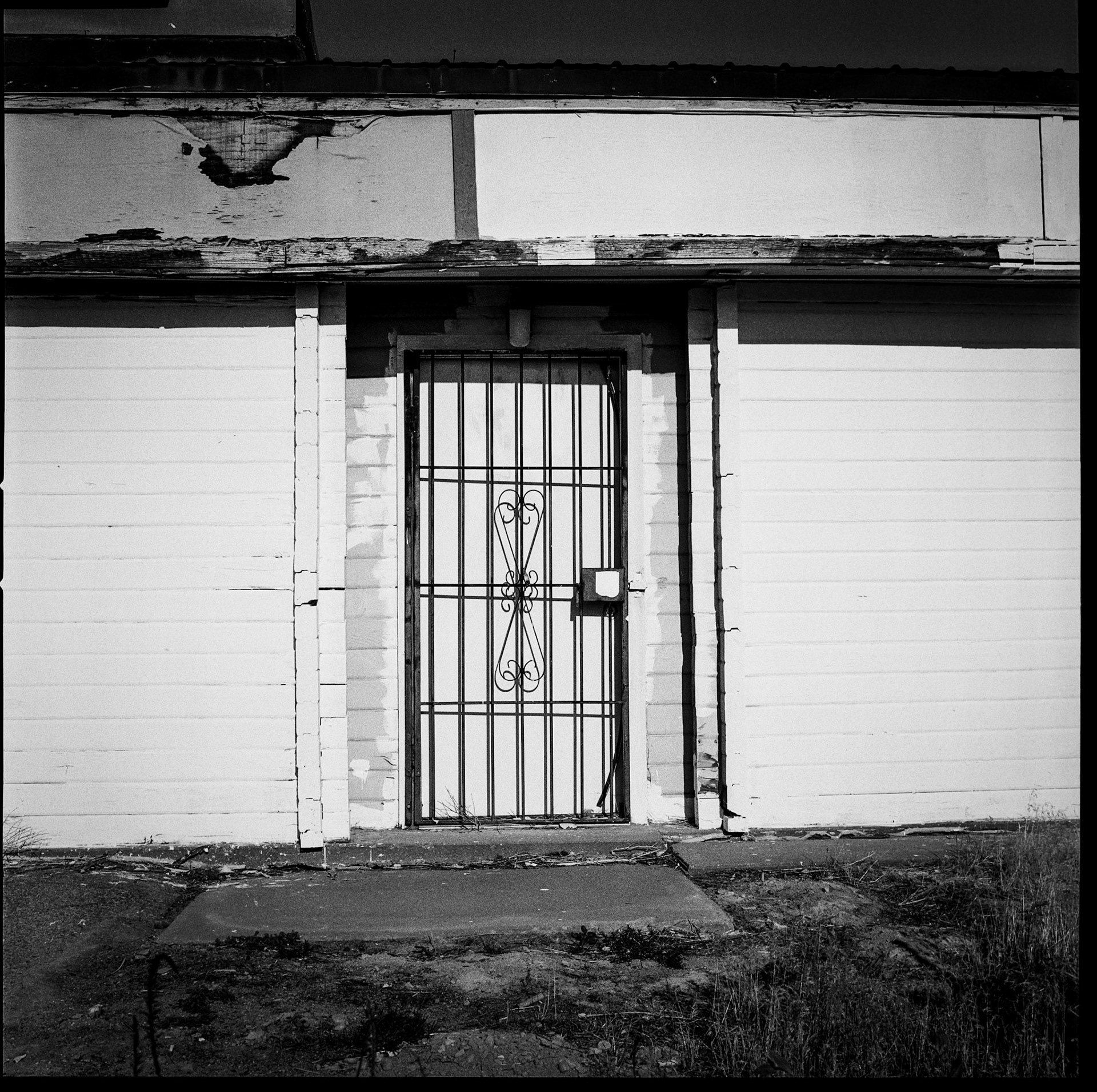 Not Analog Tuesday... On a recent outing with my 'Blad and a roll of Tri-X, I captured this door to an abandoned gas station. Still need practice with B&amp;W.
