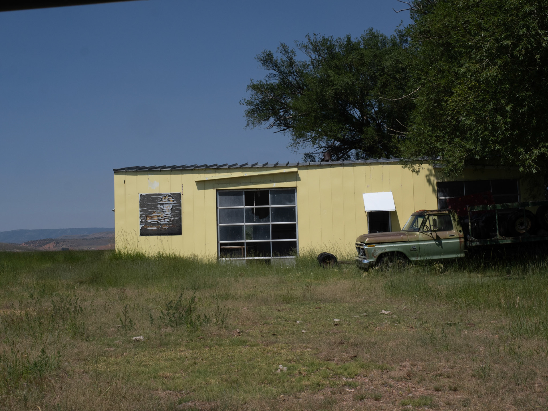 On our way home from our rafting on the Snake River, the fam allowed me to stop a little south of Randolph, Utah, to capture this photo of an old yellow garage. I found the yellow striking against the background of greens.