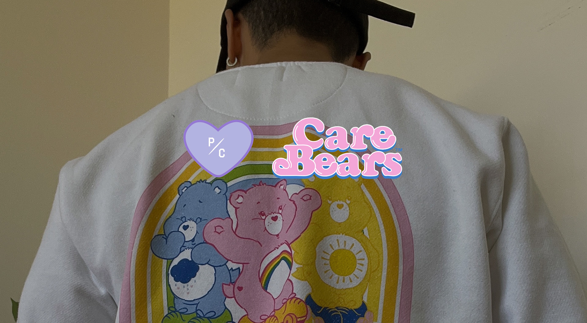 P/C x Care Bears logos overlay on top of a model wearing a crewneck sweatshirt photo
