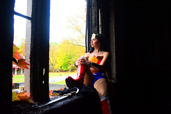 Environmental portrait using natural light, architectural framing, and balanced composition to create a cinematic Wonder Woman portrait.