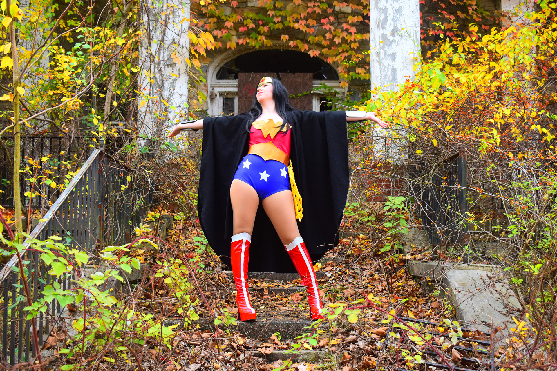 Dynamic cosplay portrait emphasizing confidence, movement, and symmetry through expressive posing and environmental composition.