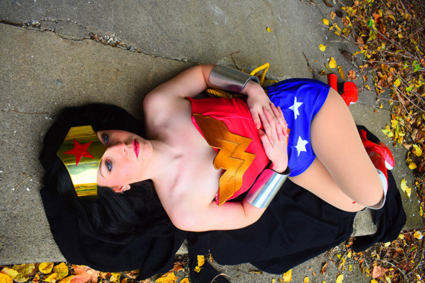 Creative cosplay portrait capturing a poised interpretation of Wonder Woman through dramatic composition and cinematic styling.
