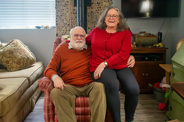 Lifestyle portrait capturing the enduring connection between an 80th birthday celebrant and his wife in their home.