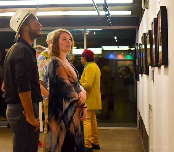 Candid event photography capturing authentic audience reactions during a local artist gallery exhibition.