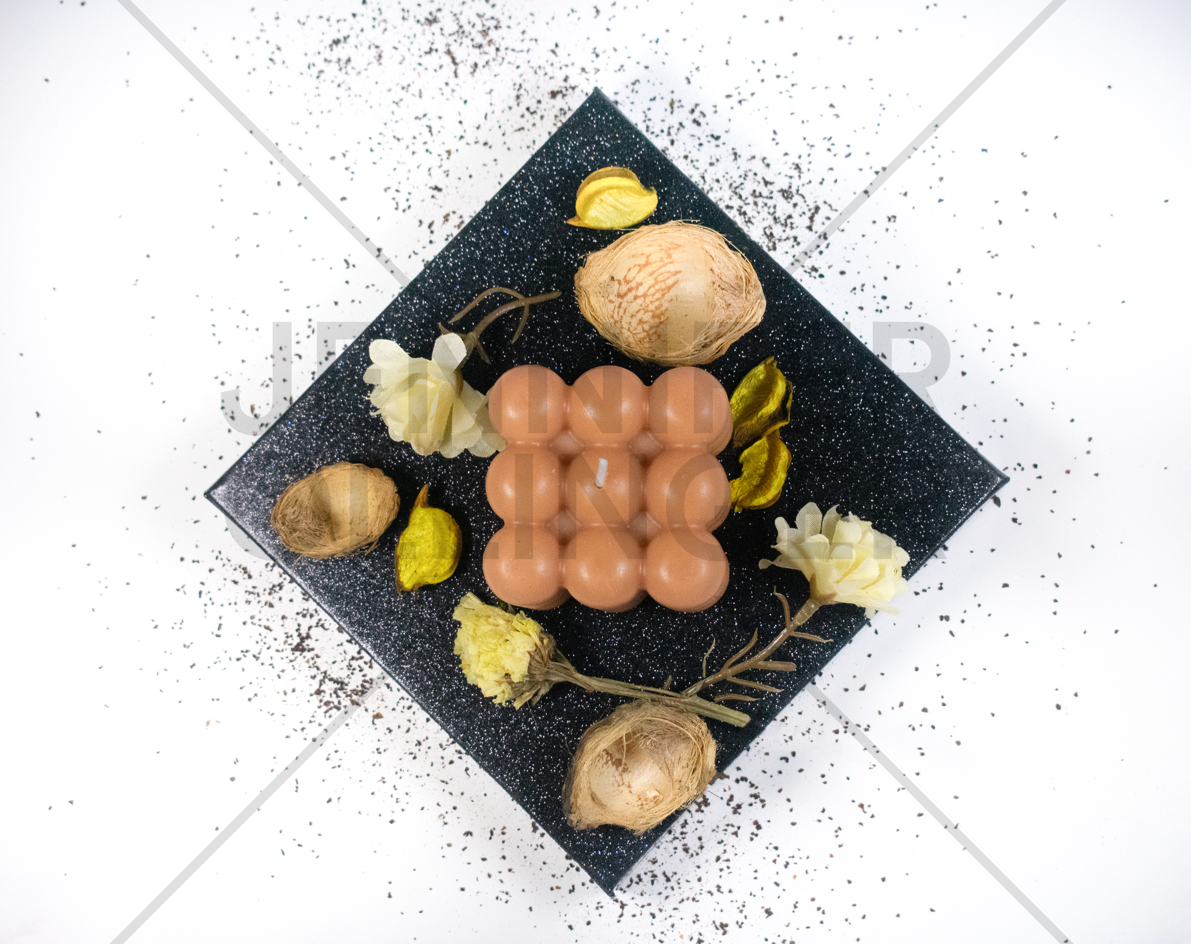 Top-down product photography showcasing the candle's fragrance profile through curated styling and complementary décor elements.