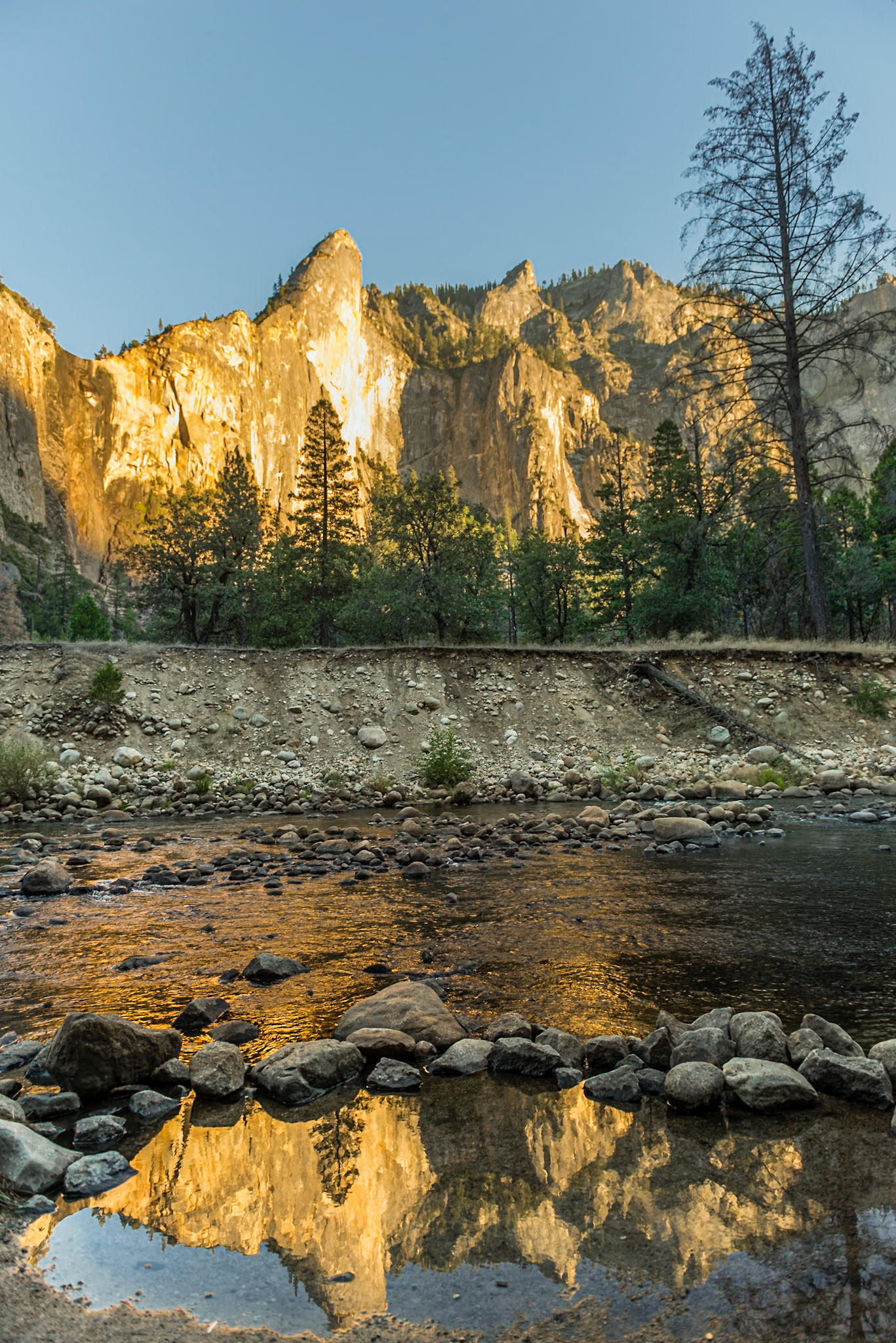 Rocky Mountains reflected on Mercer River at Yosemite National Park. California, US.