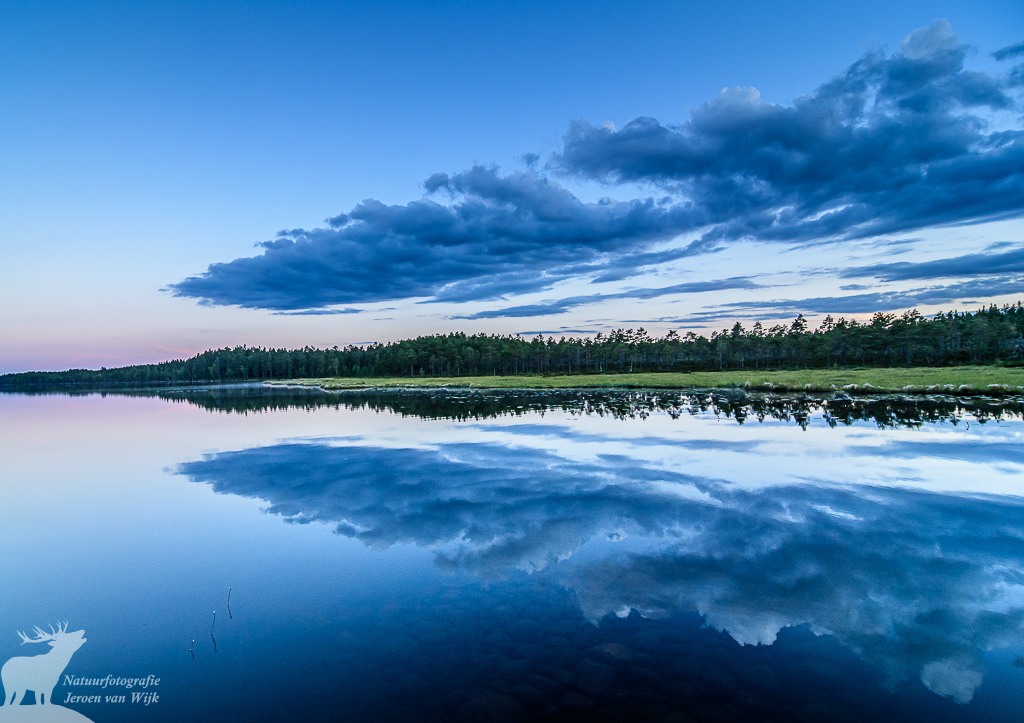 Clouds reflecting in a lake, Sweden, 2017.