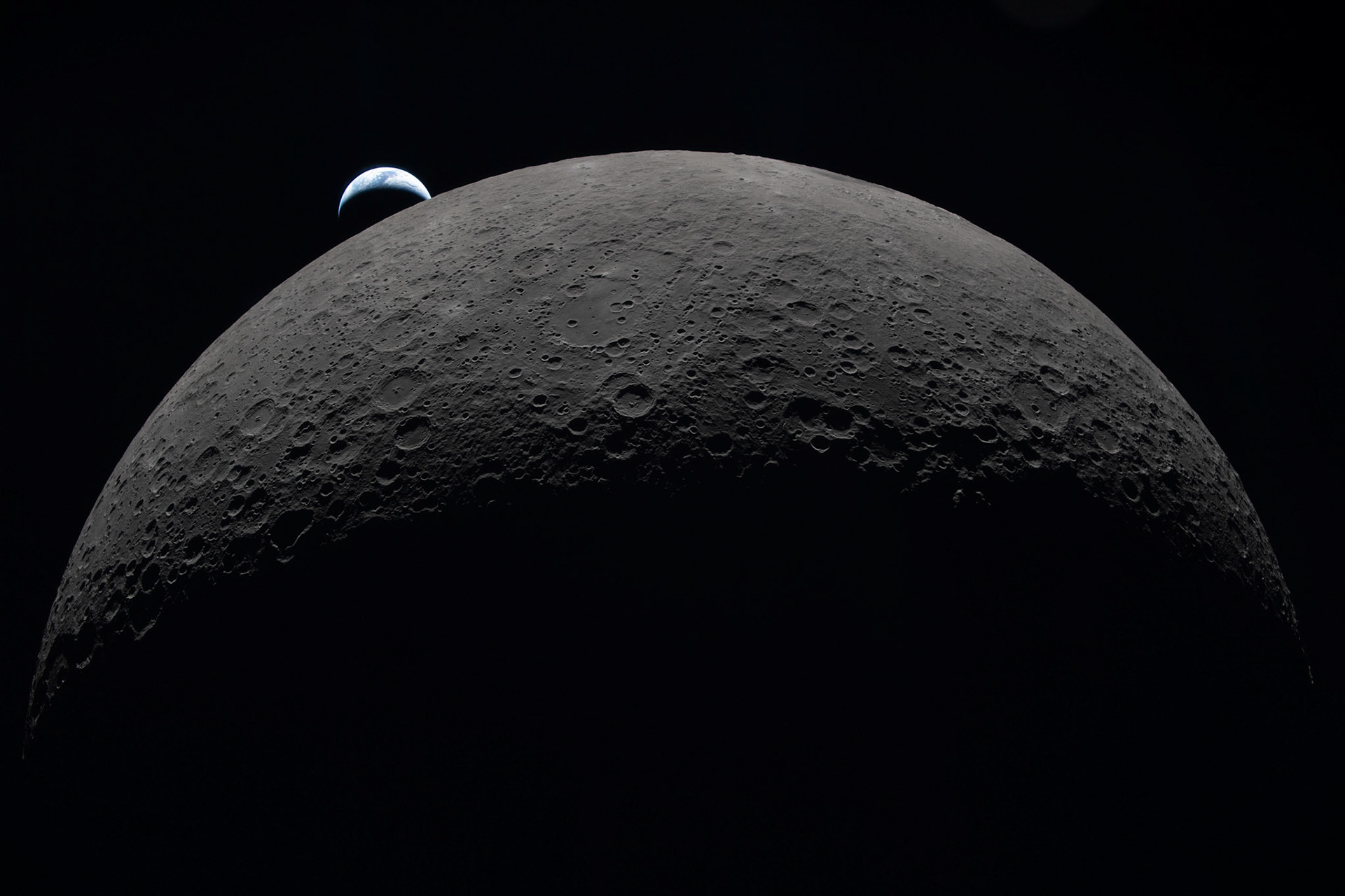 art002e009287 (April 6, 2026) – Earth sets at 6:41 p.m. EDT, April 6, 2026, over the Moon’s curved limb in this photo captured by the Artemis II crew during their journey around the far side of the Moon. Orientale basin is perched on the edge of the visible lunar surface. Hertzsprung Basin appears as two subtle concentric rings, which are interrupted by Vavilov, a younger crater superimposed over the older structure. The lines of indentations are secondary crater chains formed by ejecta from the massive impact that created Orientale.The dark portion of Earth is experiencing nighttime. On Earth’s day side, swirling clouds are visible over the Australia and Oceania region.
