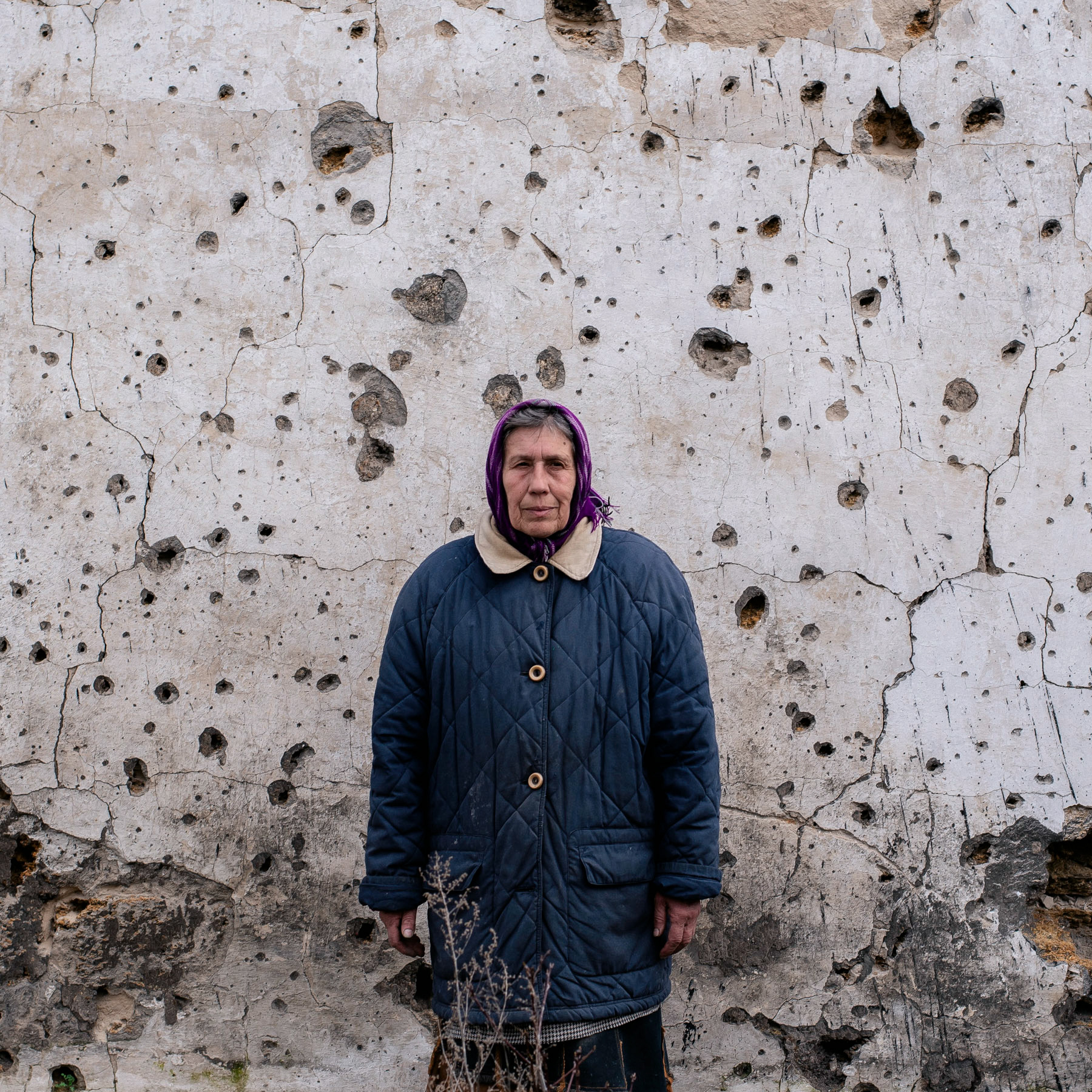 Liudmyla, a local resident of the village of Sloboda, stands beside her home destroyed by a Russian shelling attack. Chernihiv Region, Ukraine. April 6, 2023.