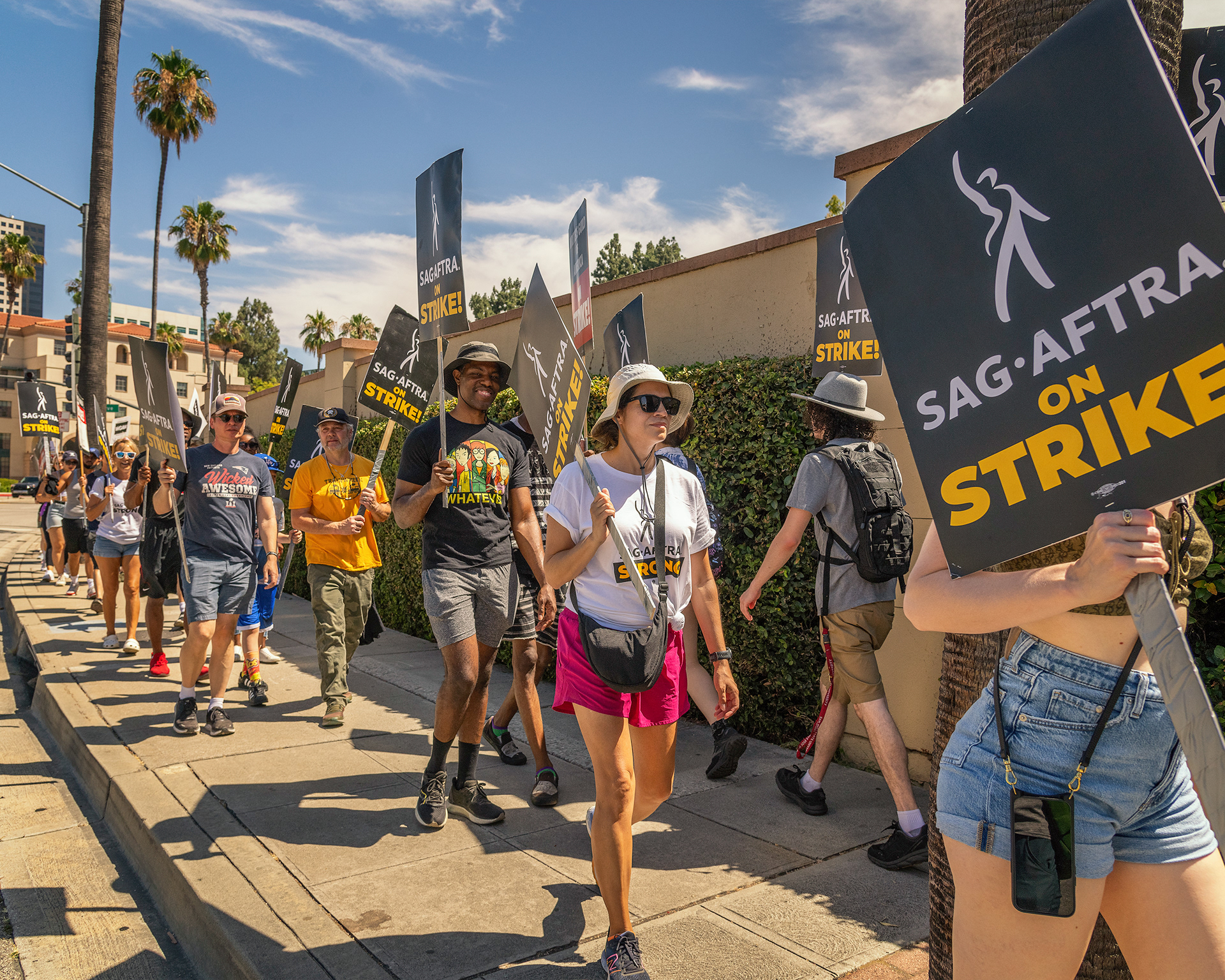 Burbank, CA, USA – July 26, 2023: Members of the Writers Guild of America, SAG and AFTRA unions strike outside Warner Brothers studio in Burbank, CA.