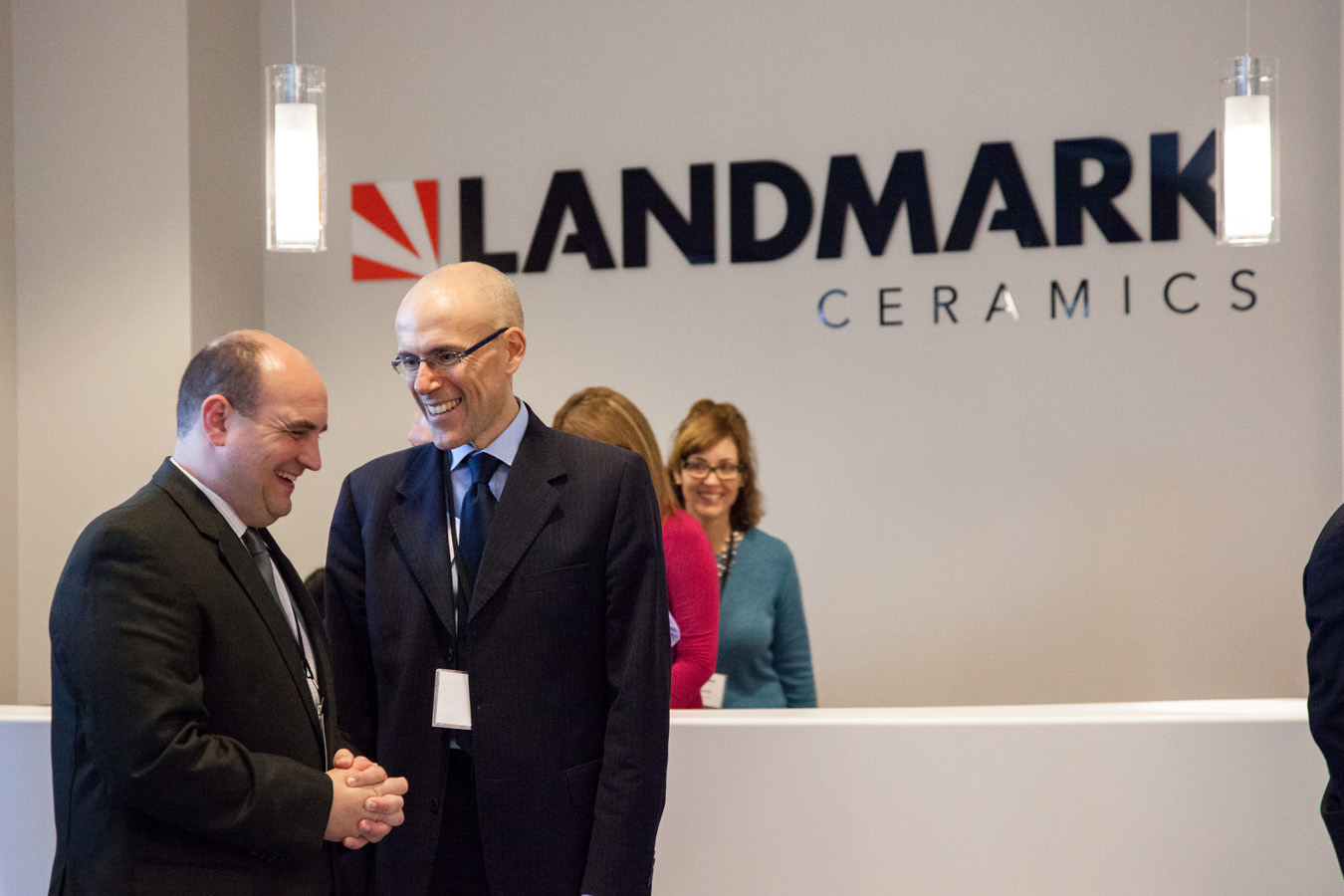 CEO of Landmark Ceramics welcomes guests at the opening reception of a new factory.