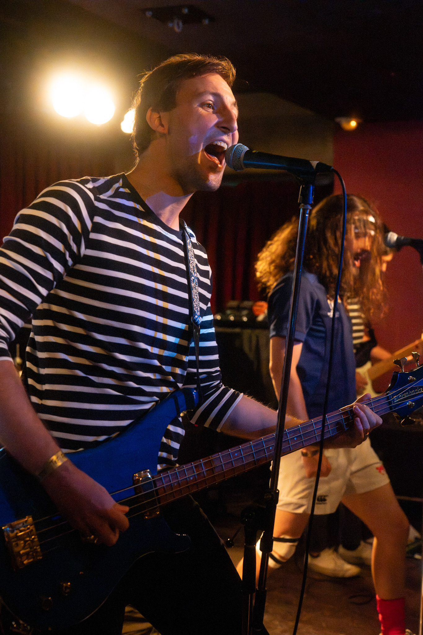 Musician mid-performance with vivid stage lights