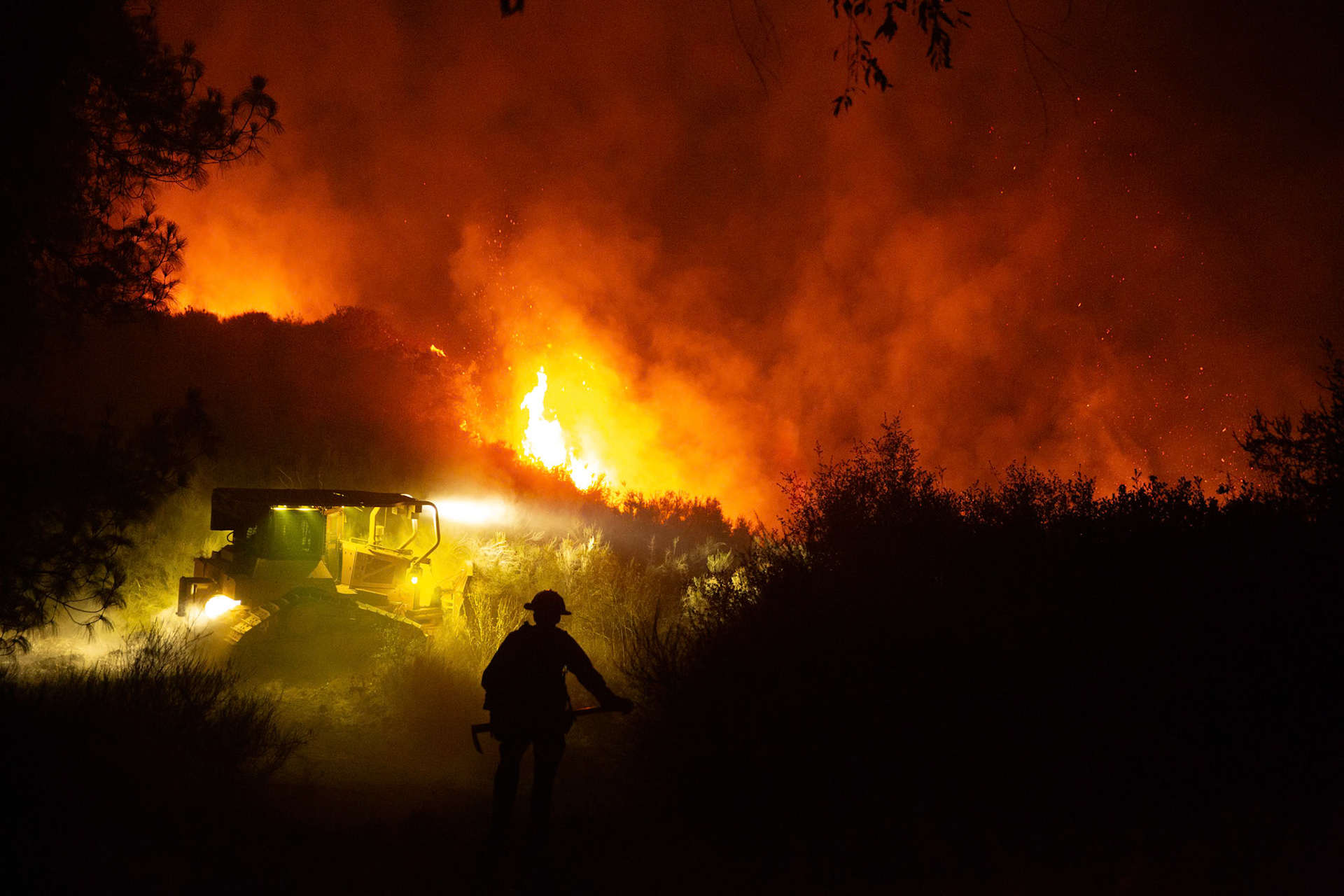 Firefighters use bulldozers and hand tools to remove vegetation in order prevent the wildfire from reaching nearby homes. The Canyon Fire started around 1:30pm on August 7, 2025 and rapidly spread to 600 acres in less than two hours. Aided by the heatwave in Southern California that reached 100 degrees Ferehnehit, dry vegetation, and steep topology; the fire has scorched more than 4,800 acres as of Thursday night.
