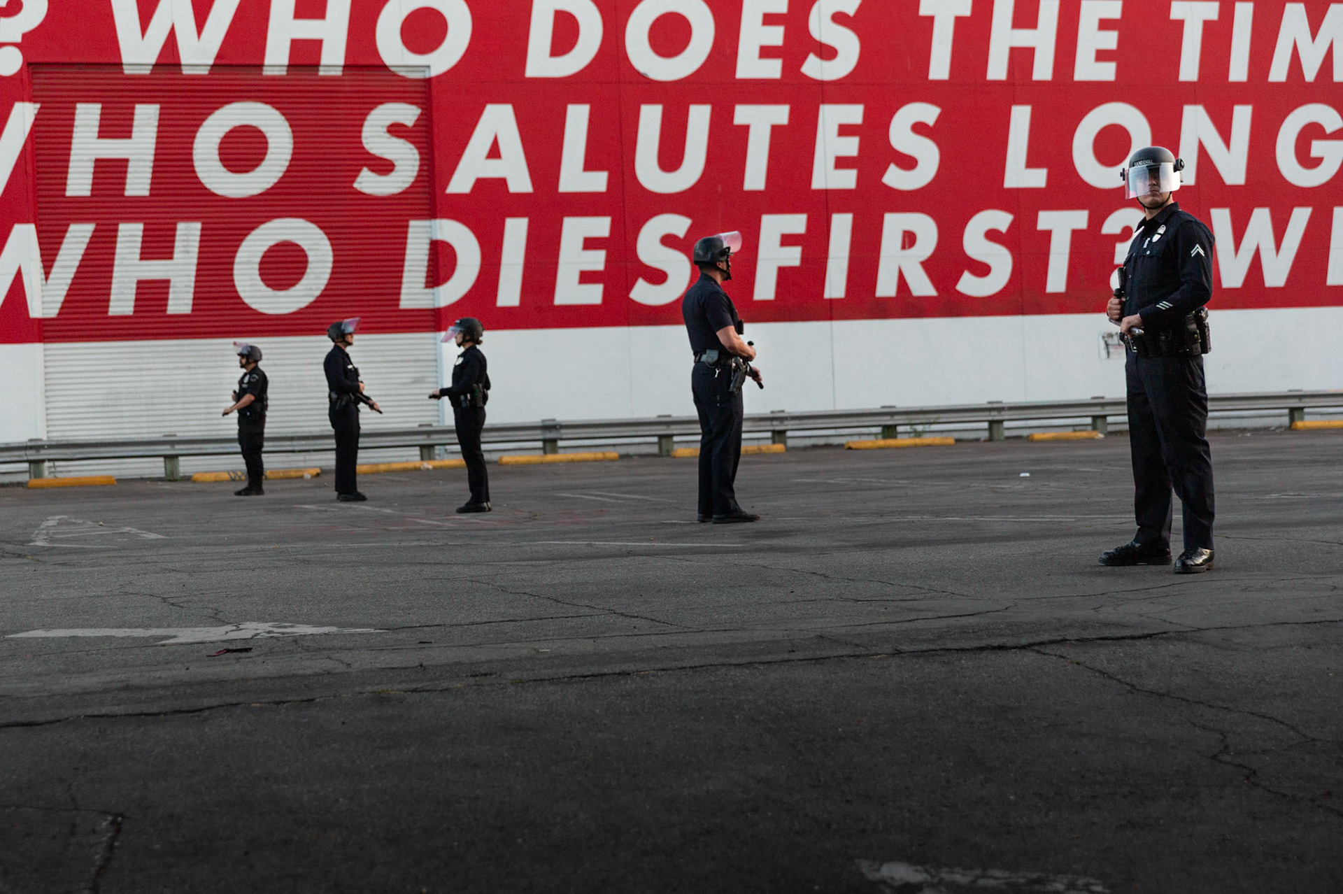 LAPD officers stand in the parking lot of the Museum of Contemporary Art in Downtown Los Angeles on June 13, 2025 during a demonstration against immigration raids by ICE.