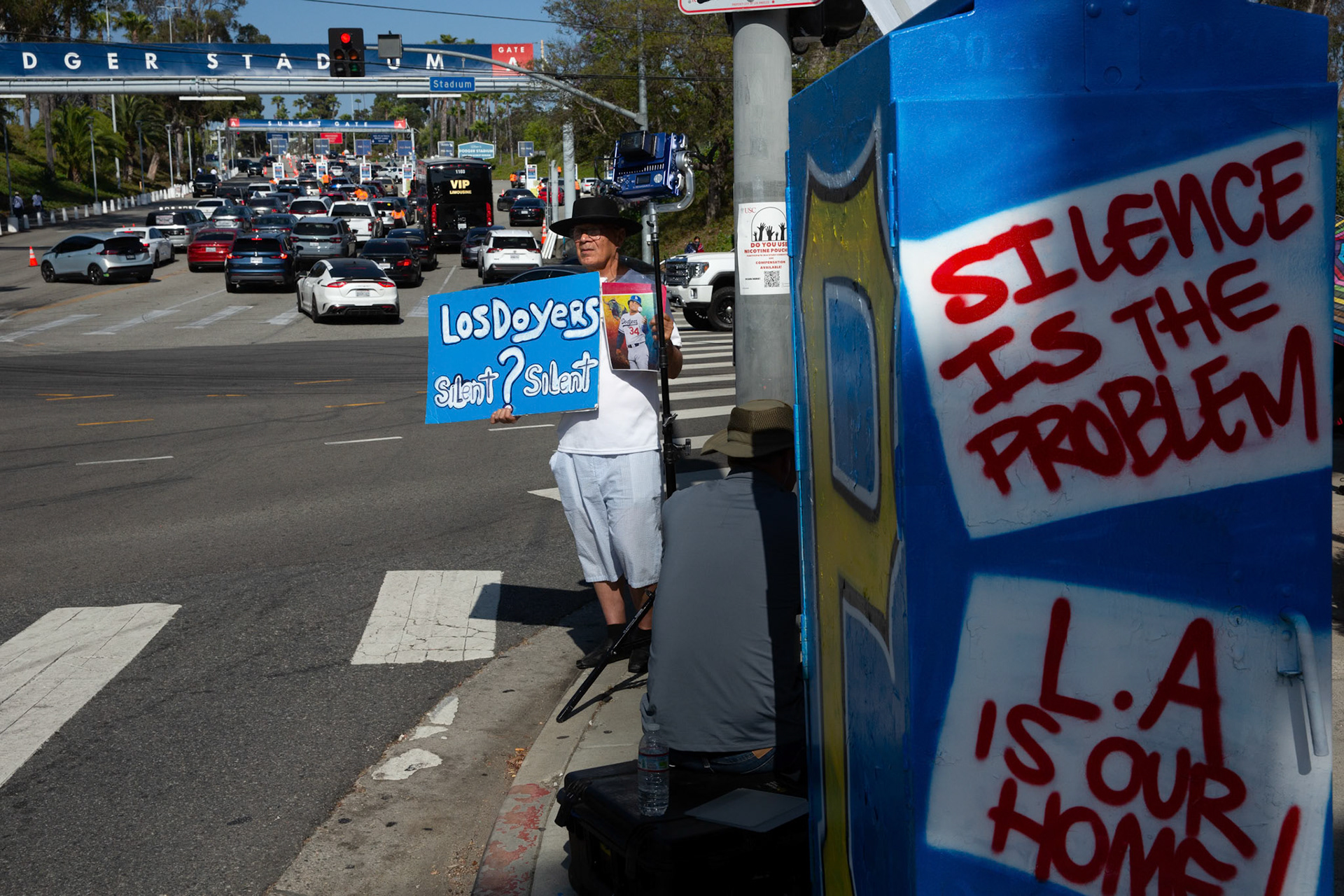 Demonstrator gather at the Dodger Stadium in Angeles, Calif. on June 19, 2025 while fans queue up to watch the baseball game between the Los Angeles Dodgers and San Diego Padres to protest the presence of ICE and Border Patrol agents at the stadium parking lot earlier in the day. A statement from Dodgers Team News website during the stand off states that the Dodgers has denied ICE agents access to the stadium.