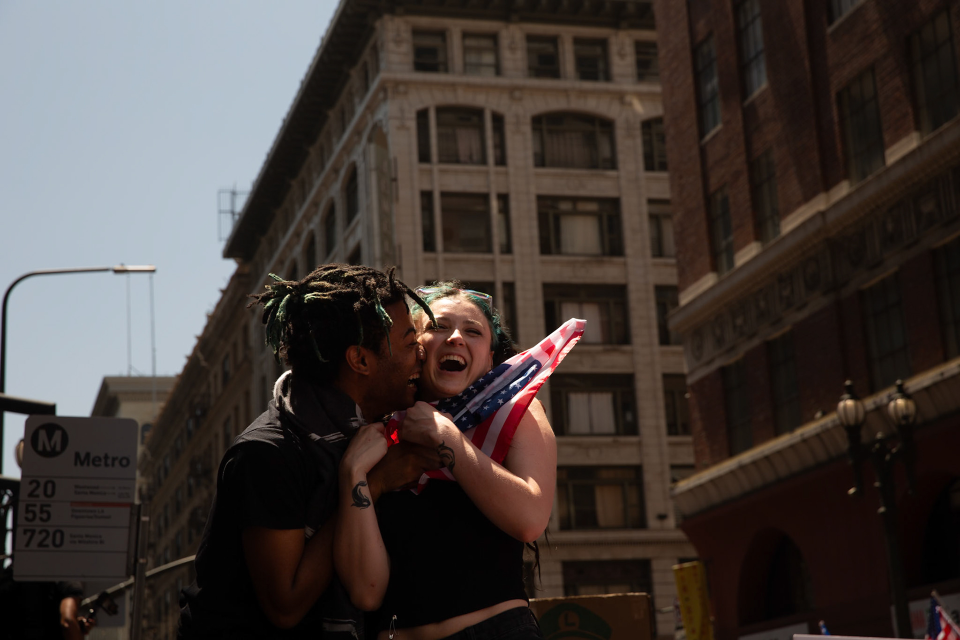Demonstrators embrace during a march against the Trump Military Parade and immigration raids by ICE in Downtown Los Angeles on June 13, 2025