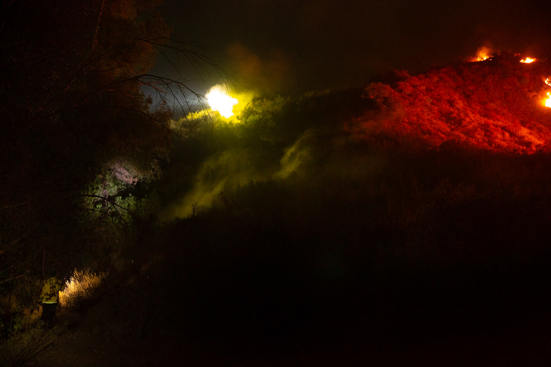 Firefighters use bulldozers and hand tools to remove vegetation in order prevent the wildfire from reaching nearby homes. The Canyon Fire started around 1:30pm on August 7, 2025 and rapidly spread to 600 acres in less than two hours. Aided by the heatwave in Southern California that reached 100 degrees Ferehnehit, dry vegetation, and steep topology; the fire has scorched more than 4,800 acres as of Thursday night.