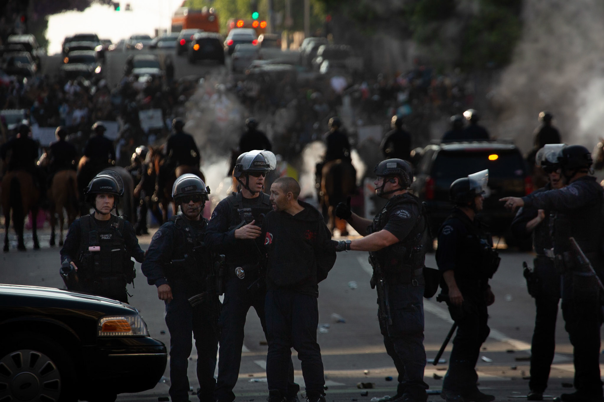 A demoonstrator is arrested as LAPD officers charge demonstrators on horseback while rubber bullets and tear gas is fired into the crowd in Donwtown Los Angeles, Calif. on June 8, 2025 during a protest against immigration raids conducted by ICE and Federal police.