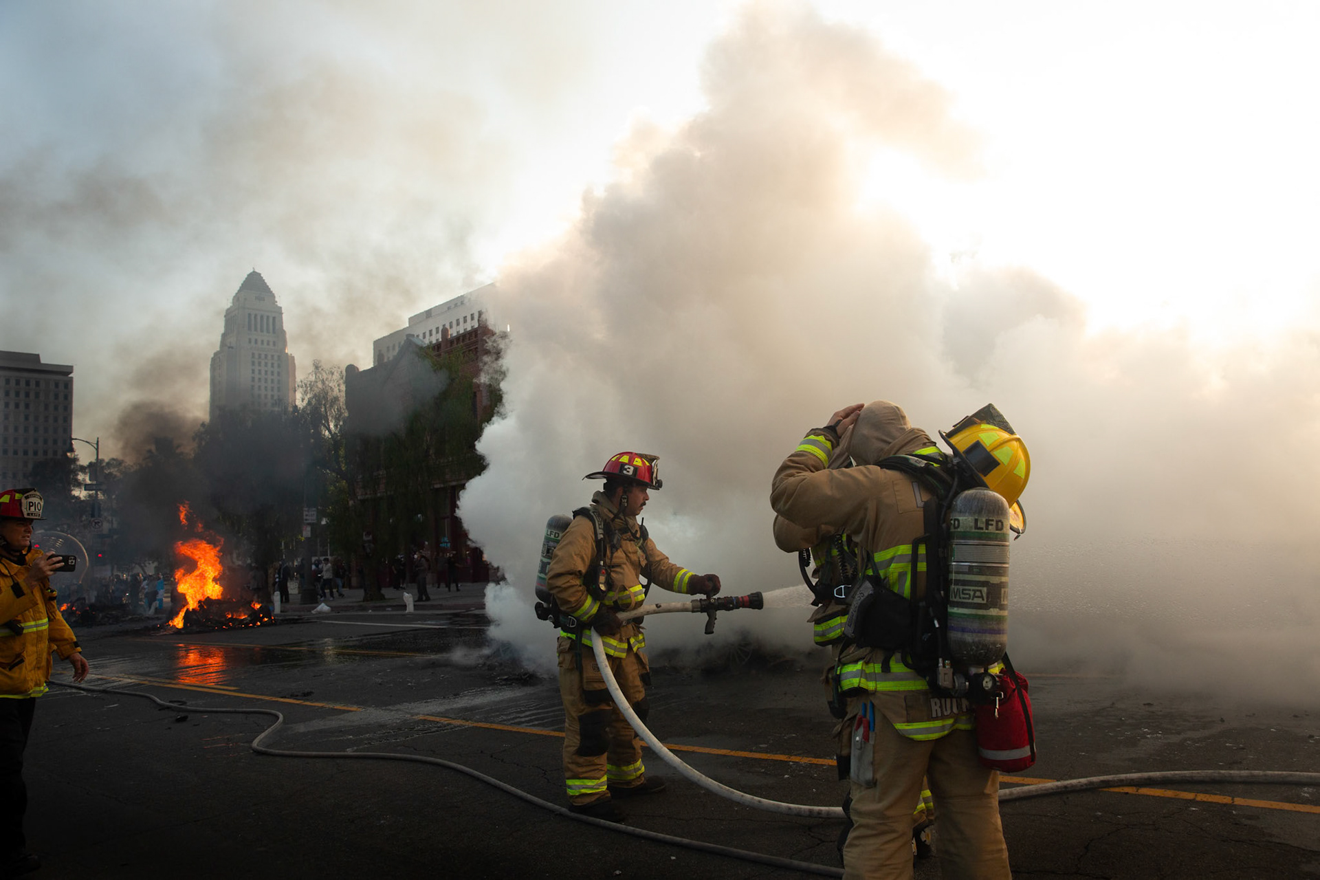 Friefighters extinguish driverless robo-taxis in Donwtown Los Angeles, Calif. on June 8, 2025 during a protest against immigration raids conducted by ICE and Federal police.