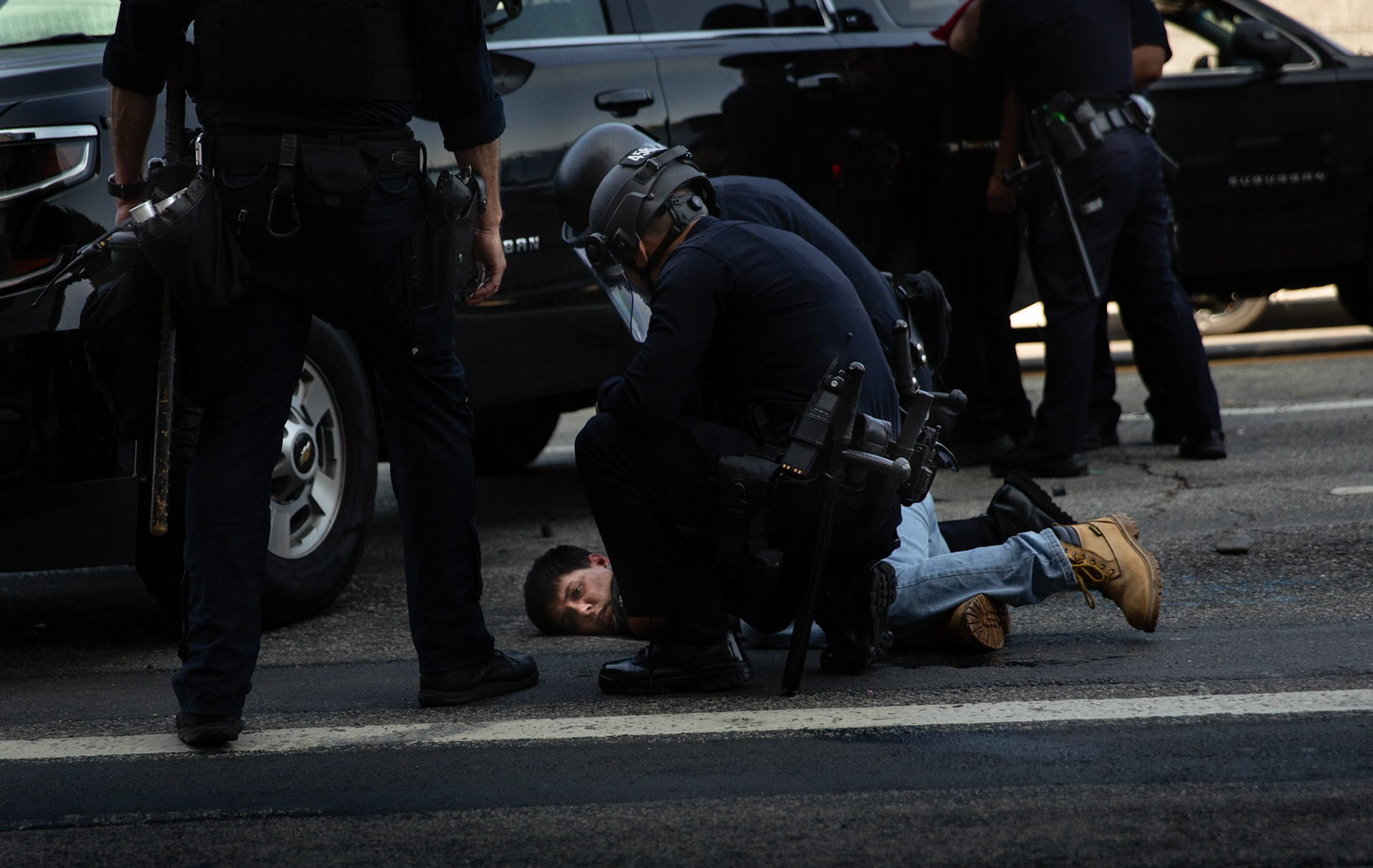 LAPD officers arrest a demonstrator in front of the Metropolitan Detention Center in Donwtown Los Angeles, Calif. on June 8, 2025 during a protest against immigration raids conducted by ICE and Federal police.