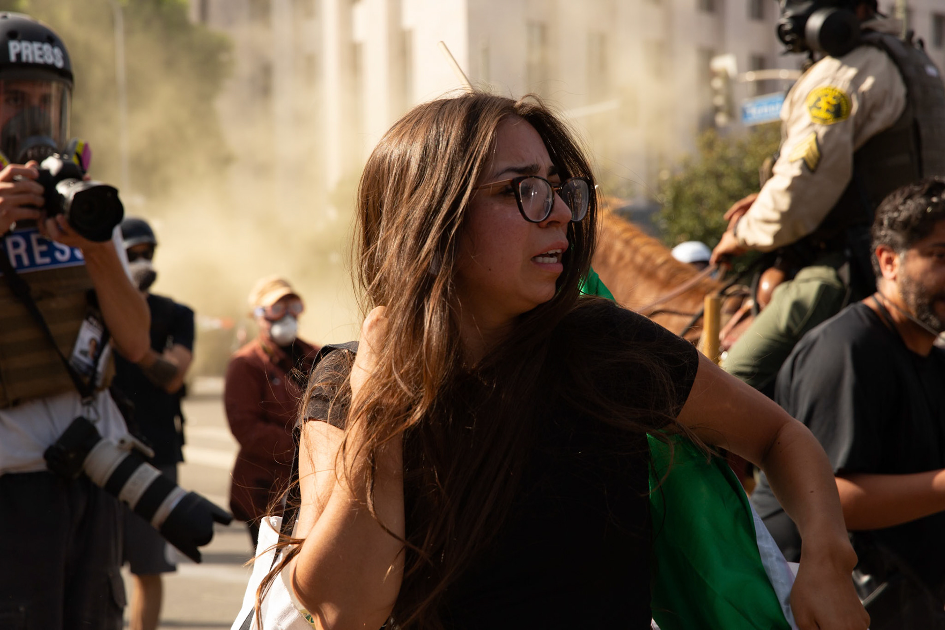 A demonstrator cries and attempts to rescue her cousin who is being tackled and plastic zip tied by Los Angeles County Shriffs during a march against the Trump Military Parade and immigration raids by ICE in Downtown Los Angeles on June 13, 2025