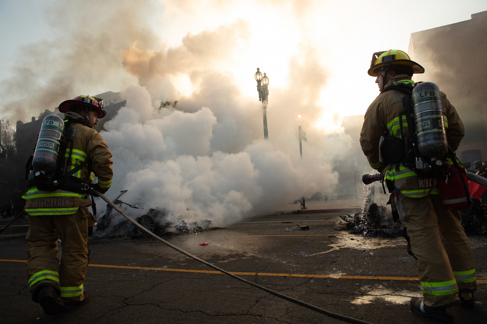 Friefighters extinguish driverless robo-taxis in Donwtown Los Angeles, Calif. on June 8, 2025 during a protest against immigration raids conducted by ICE and Federal police.