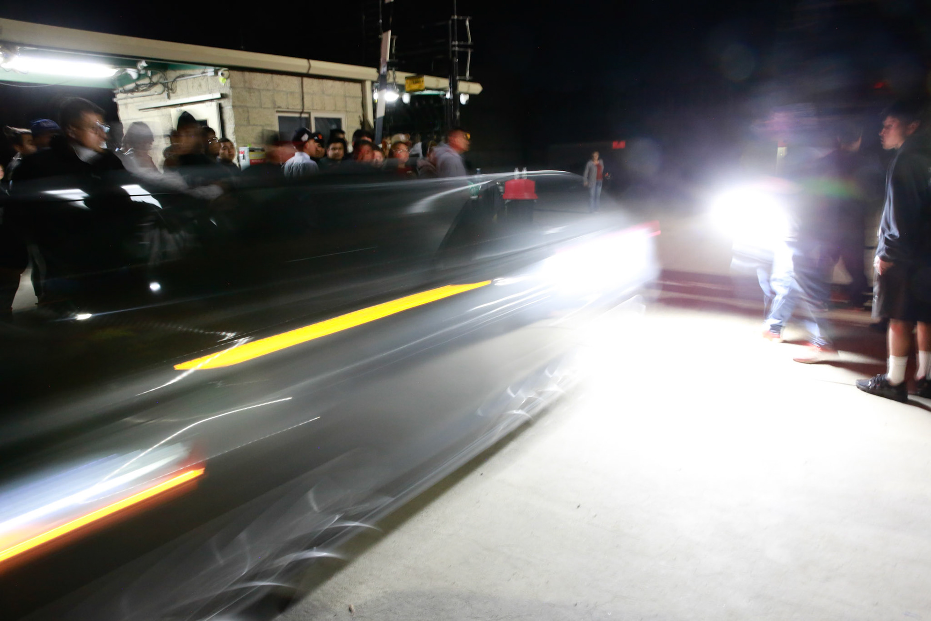Workers drive out of the farm facility as families anxiously wait for their loved ones to come out of the farm facility after a mass immigraiton raid condicted by ICE and multiple DHs agencies in Camarillo, Calif. on July 10, 2025