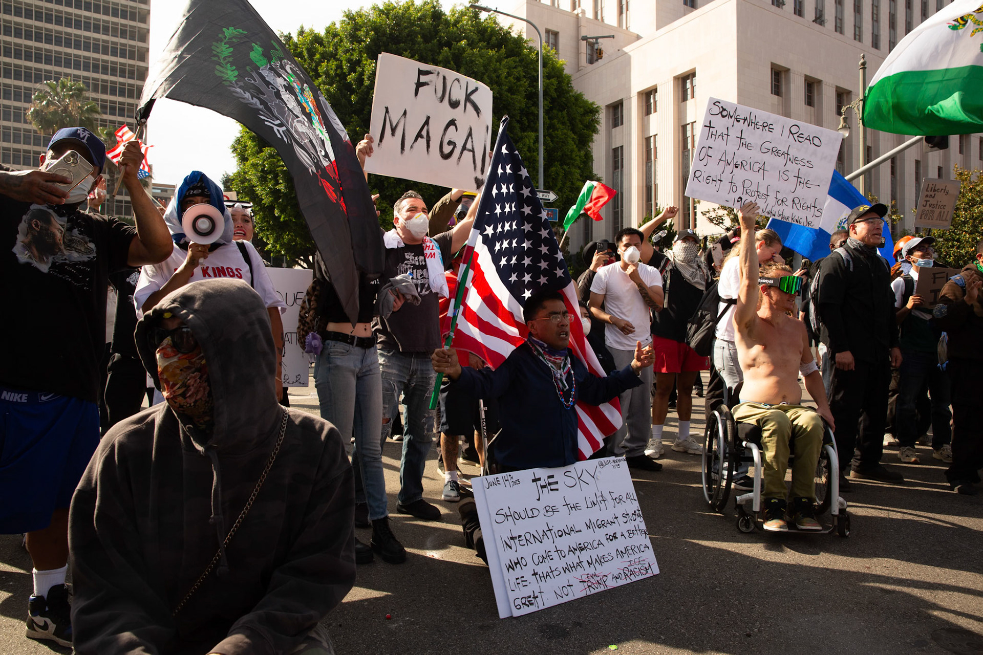 A demonstrator implpres the Los Angeles County Shriffs to stop firing after Sheriffs fired tear gas and flash bang grenades during a march against the Trump Military Parade and immigration raids by ICE in Downtown Los Angeles on June 13, 2025