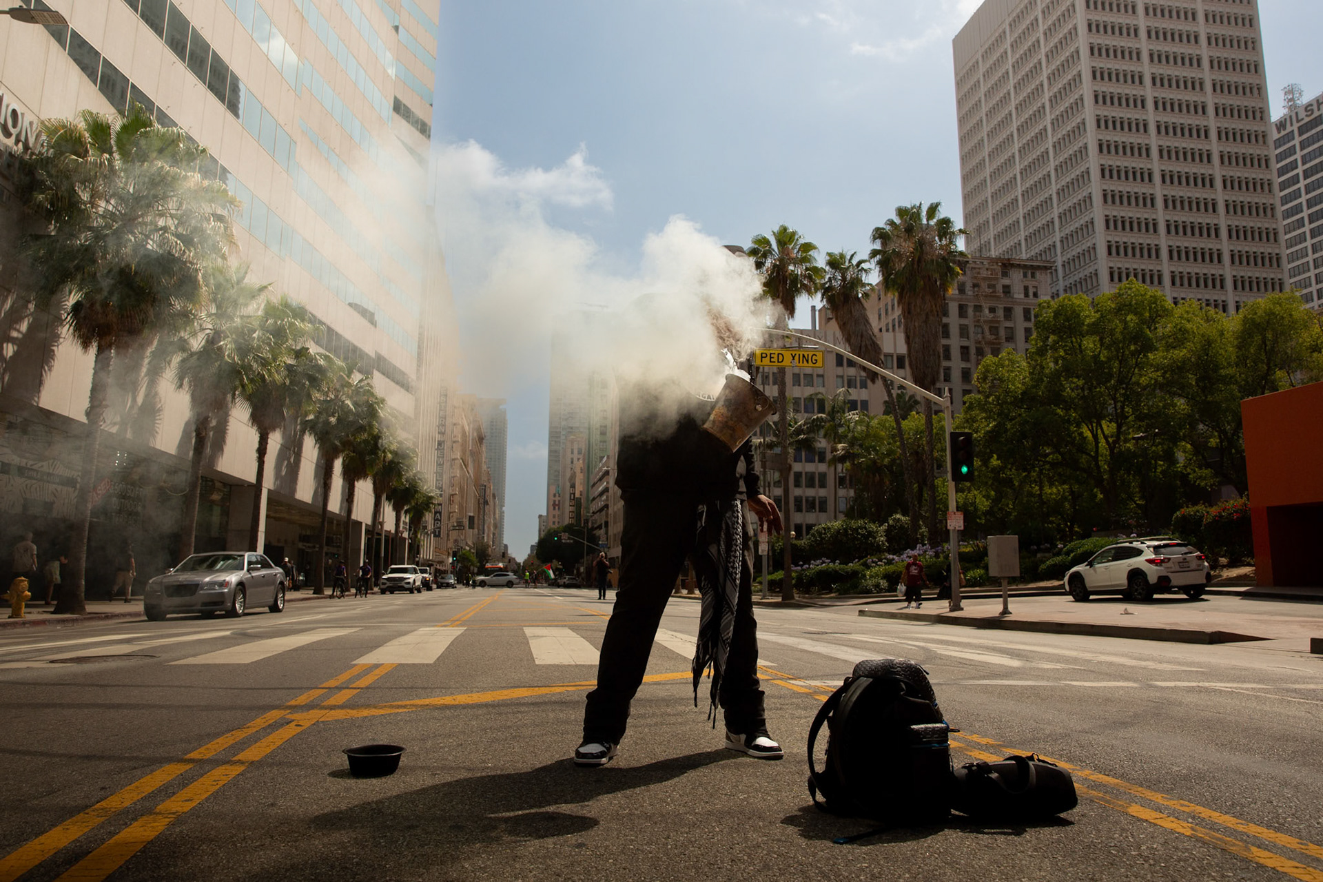 Demonstrators burn sage at Pershing Square in Los Angeles Calif. on June 21, 2025 during a demonstration against U.S. involvement in the war between Israel and Iran.
