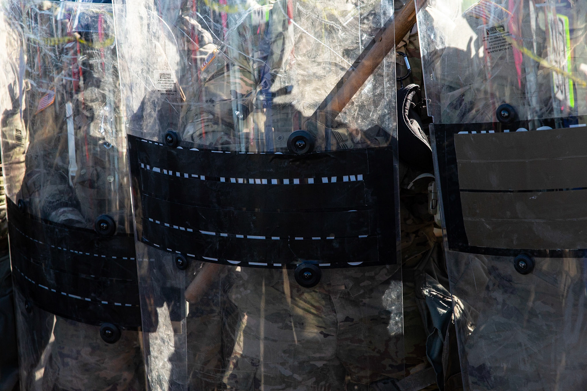 National Guards taped over the identifying logo on their shields at a farm. DHS agents from multiple subsidiaries conducts a mass raid at a farm in Camarillo, Calif. on July 10, 2025.