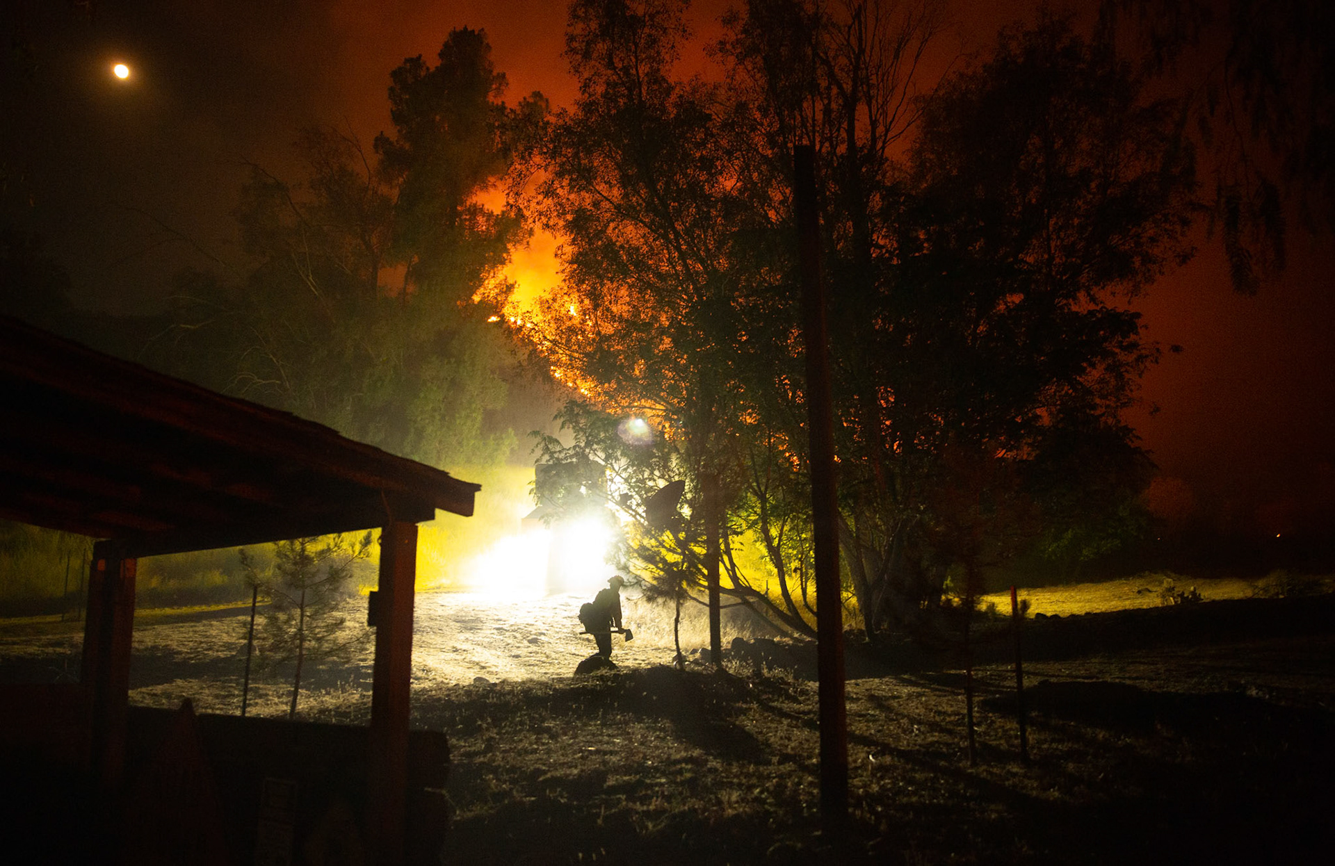 Firefighters use bulldozers and hand tools to remove vegetation in order prevent the wildfire from reaching nearby homes. The Canyon Fire started around 1:30pm on August 7, 2025 and rapidly spread to 600 acres in less than two hours. Aided by the heatwave in Southern California that reached 100 degrees Ferehnehit, dry vegetation, and steep topology; the fire has scorched more than 4,800 acres as of Thursday night.