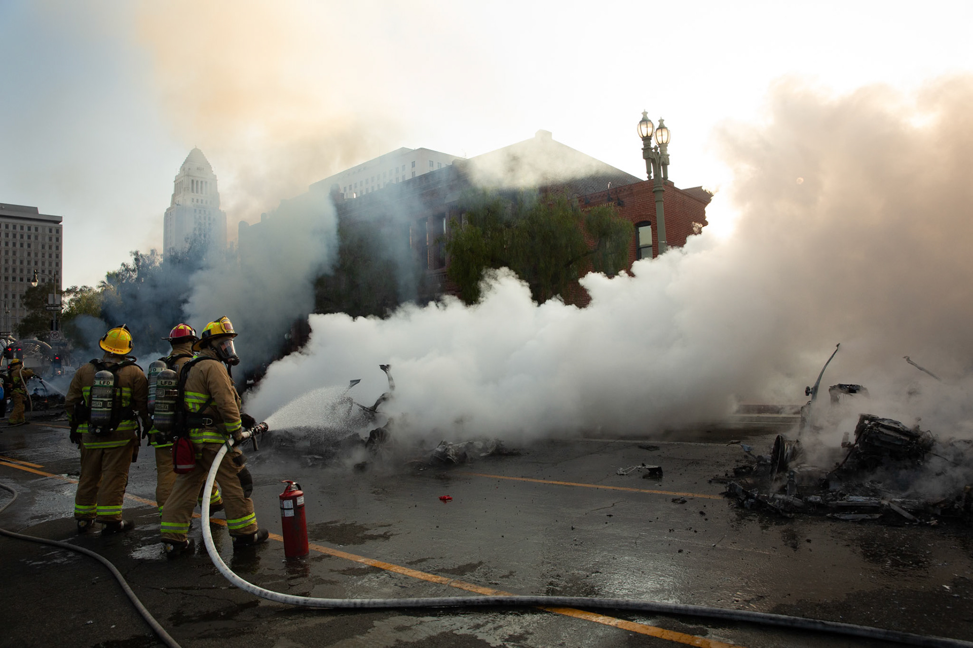 Friefighters extinguish driverless robo-taxis in Donwtown Los Angeles, Calif. on June 8, 2025 during a protest against immigration raids conducted by ICE and Federal police.