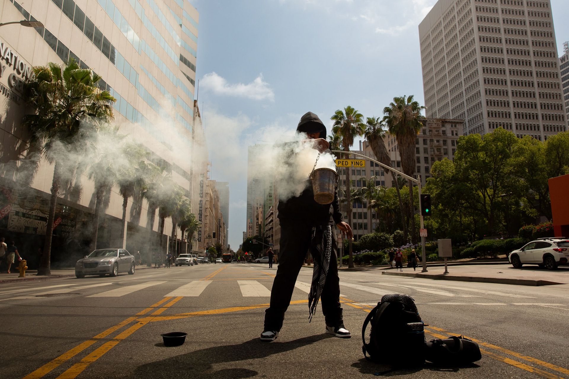 Demonstrators burn sage at Pershing Square in Los Angeles Calif. on June 21, 2025 during a demonstration against U.S. involvement in the war between Israel and Iran.