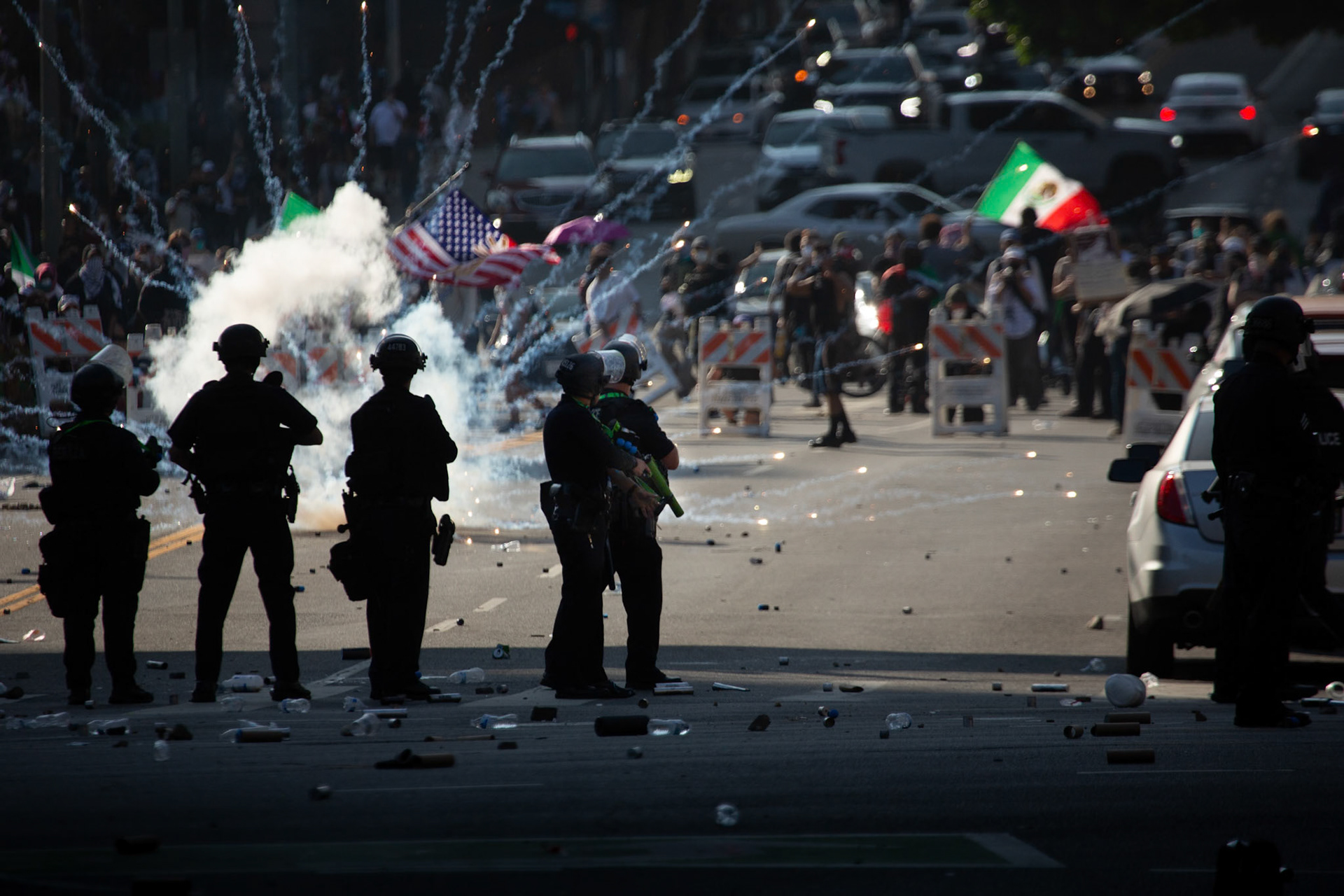 Demonstrators respond by setting off fireworks after LAPD officers fire rubber bulets and tear gas rubber bullets and tear gas into the crowd in Donwtown Los Angeles, Calif. on June 8, 2025 during a protest against immigration raids conducted by ICE and Federal police.