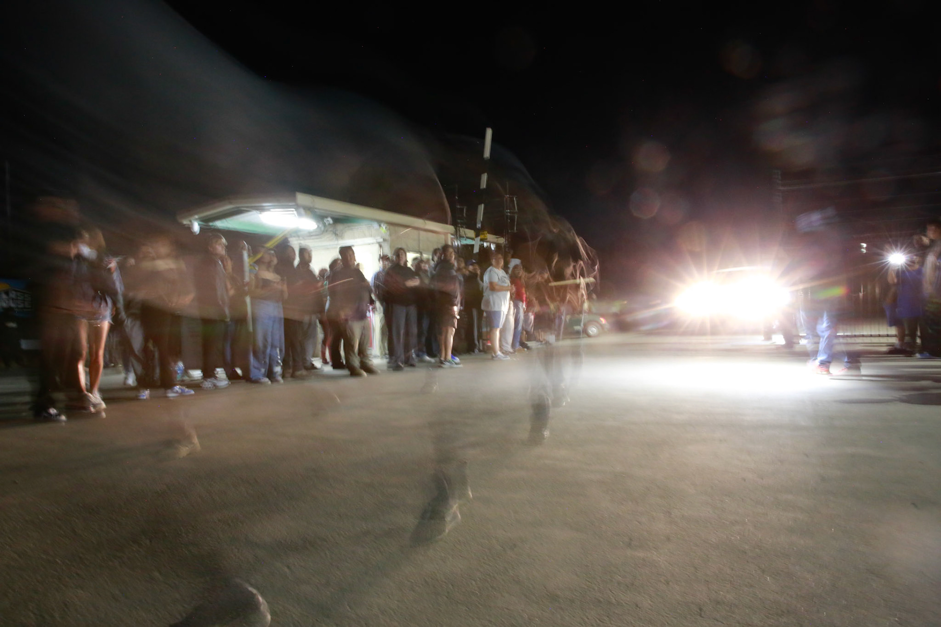 A worker runs out of the farm facility as families anxiously wait for their loved ones to come out of the farm facility after a mass immigraiton raid condicted by ICE and multiple DHs agencies in Camarillo, Calif. on July 10, 2025