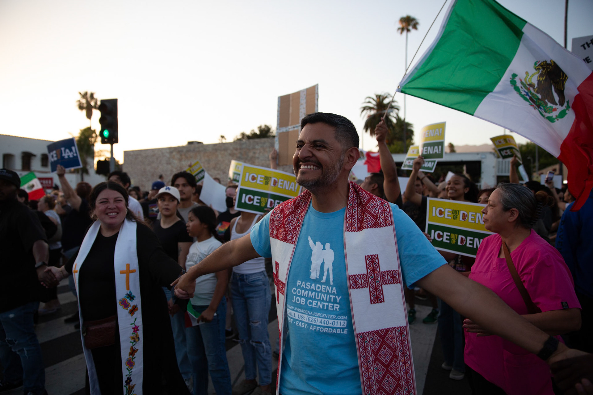 Pastor Marcos Canales of La Fuente Ministreies and Mayra Macedo-Nolan of Clergy Community Coalition hold hands with clergy from various local religious demoniations to form a human chain in Pasadena, Calif. on June 18, 2025 to demonstrate against immigration raids conducted by ICE and Federal police. Canales says he is attending the demonstration because god had to flee as an migrant and the immigrants of the United States deserve recognition for their contribition to the country.